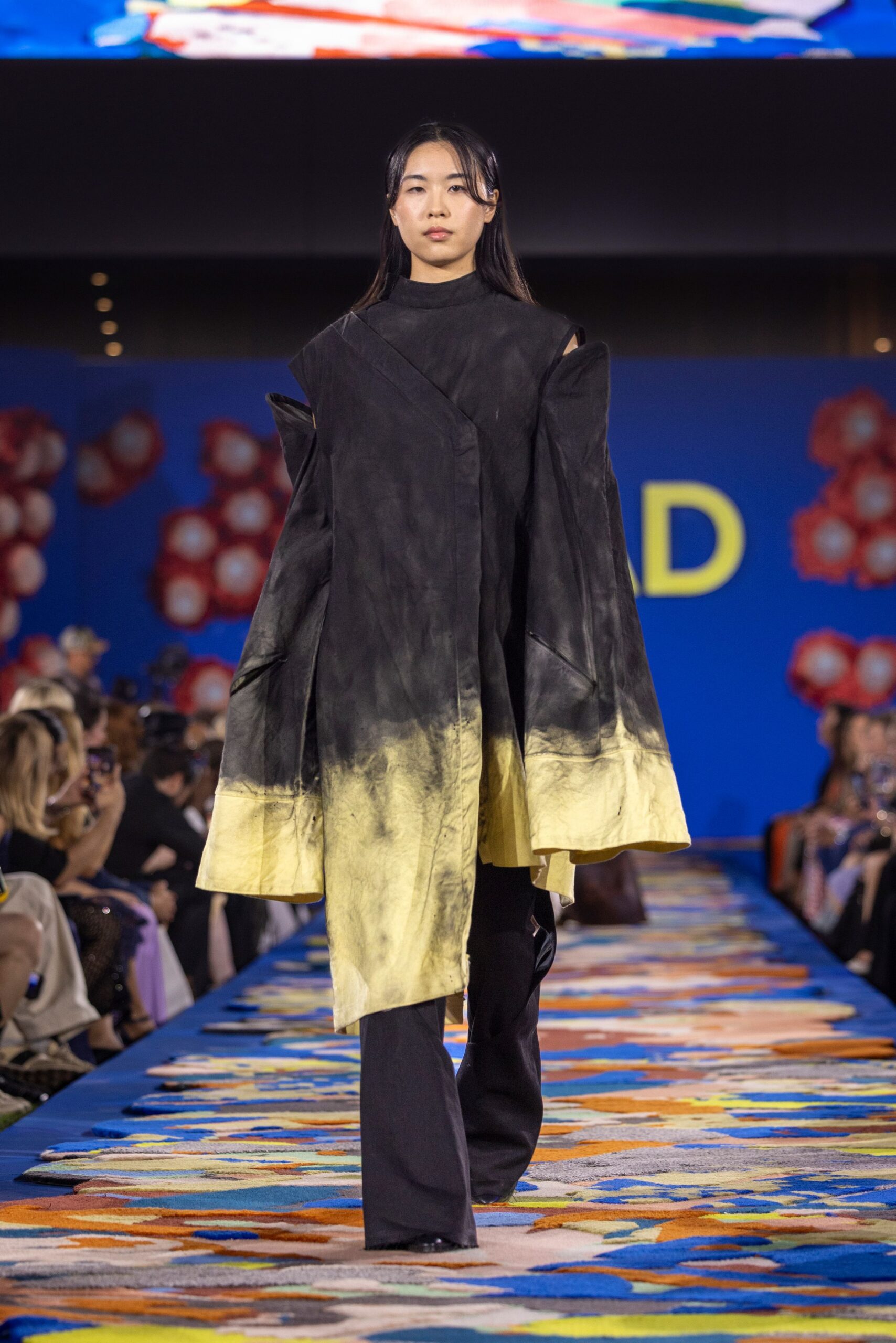 black and gold draped coat with fitted pants