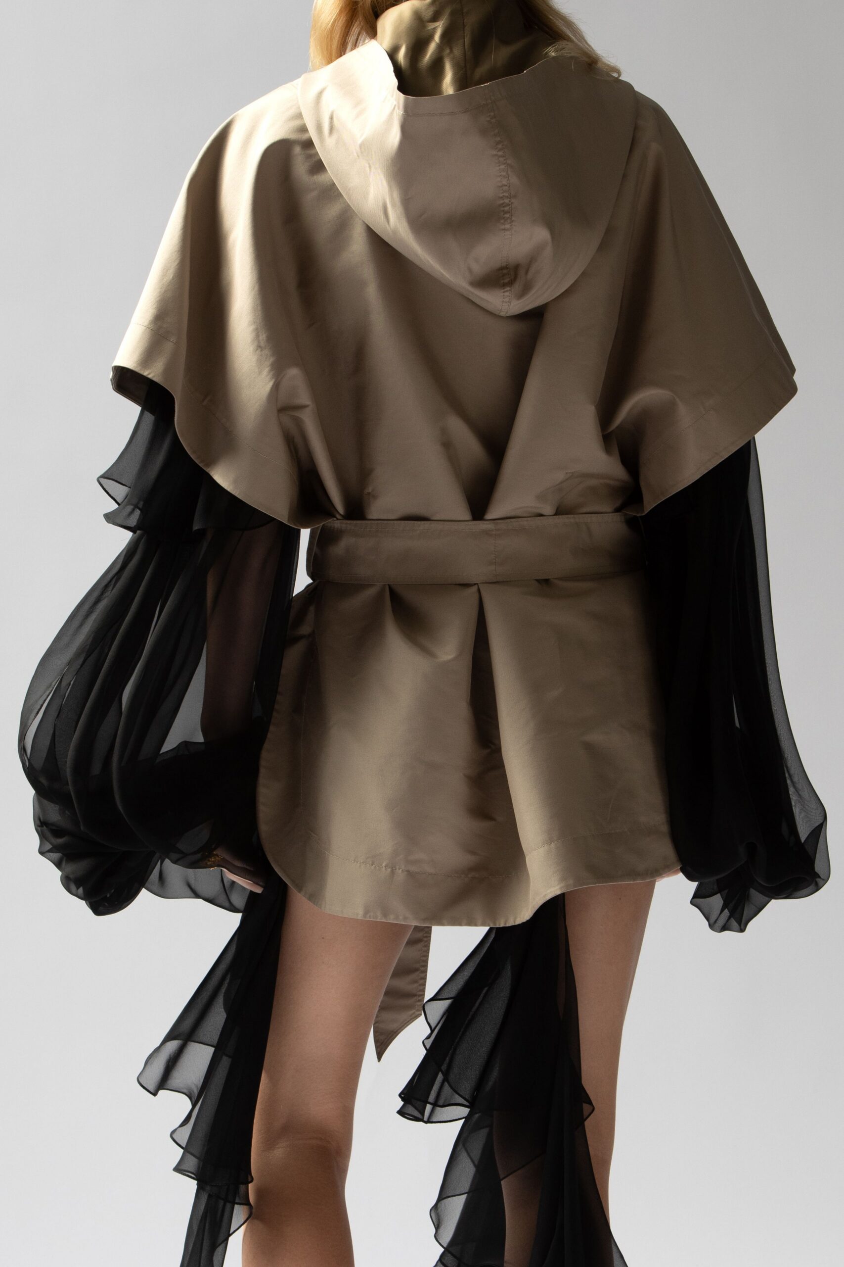 beige and black flowing coat
