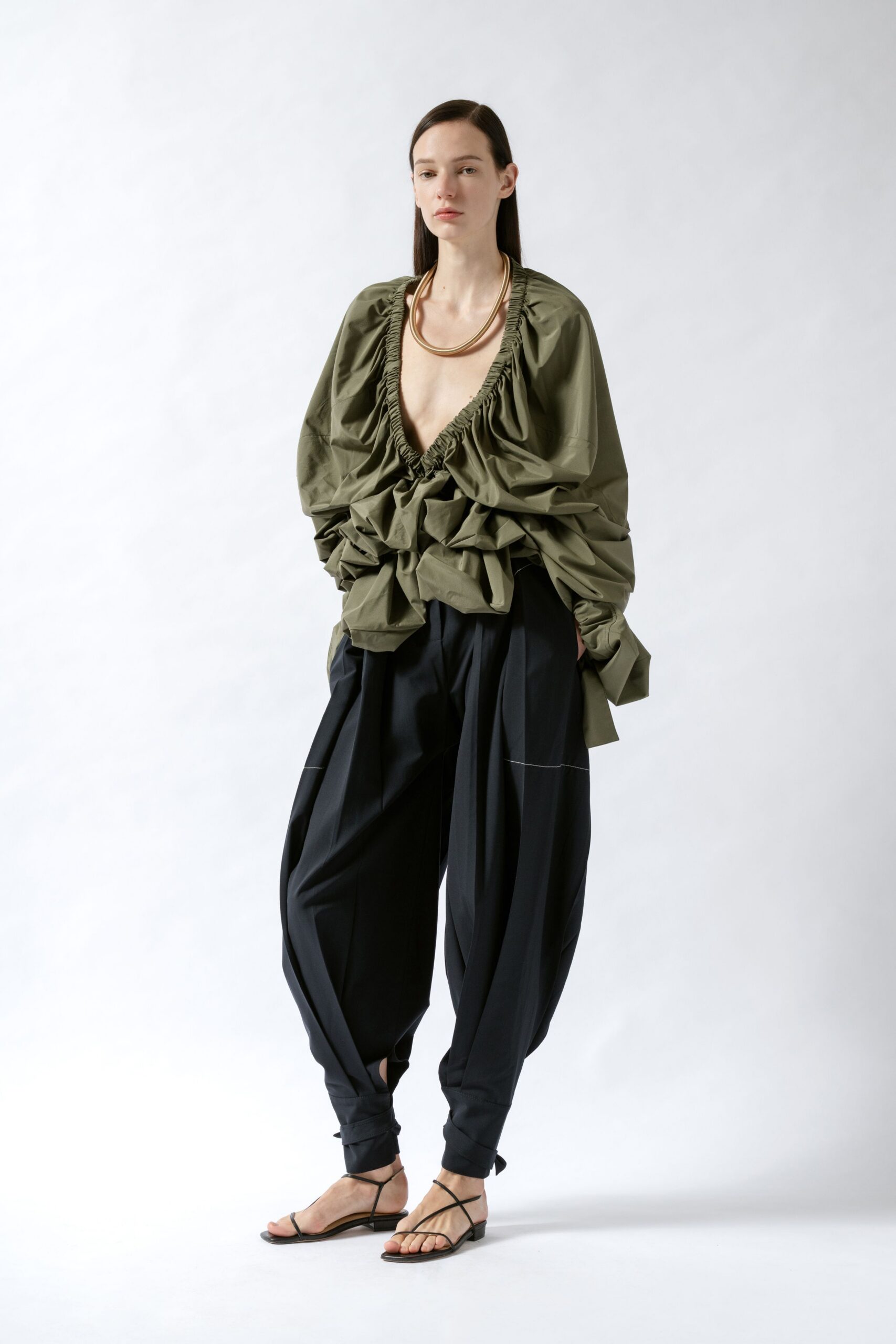green relaxed top with black pants