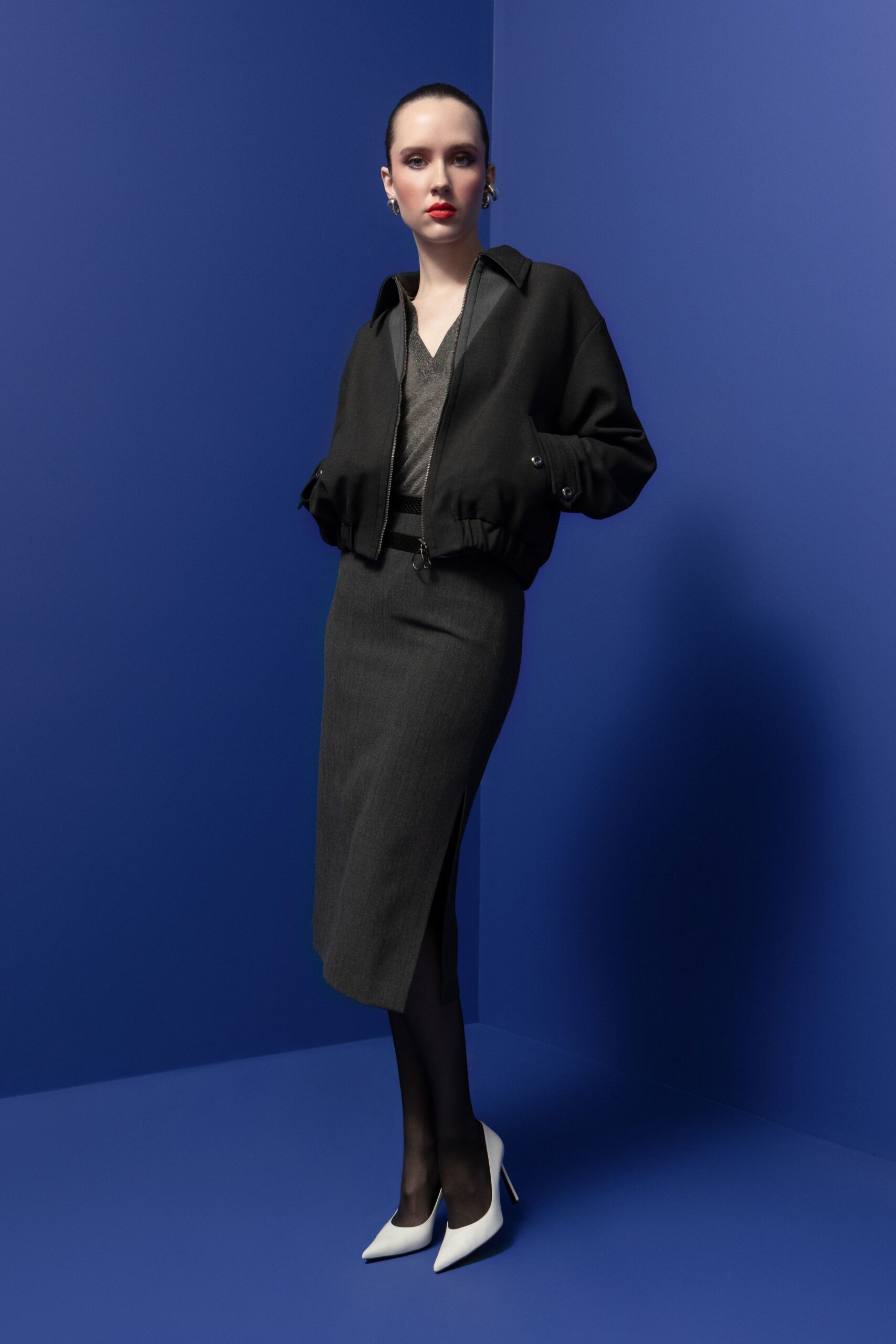 black jacket gray top black skirt white shoes
