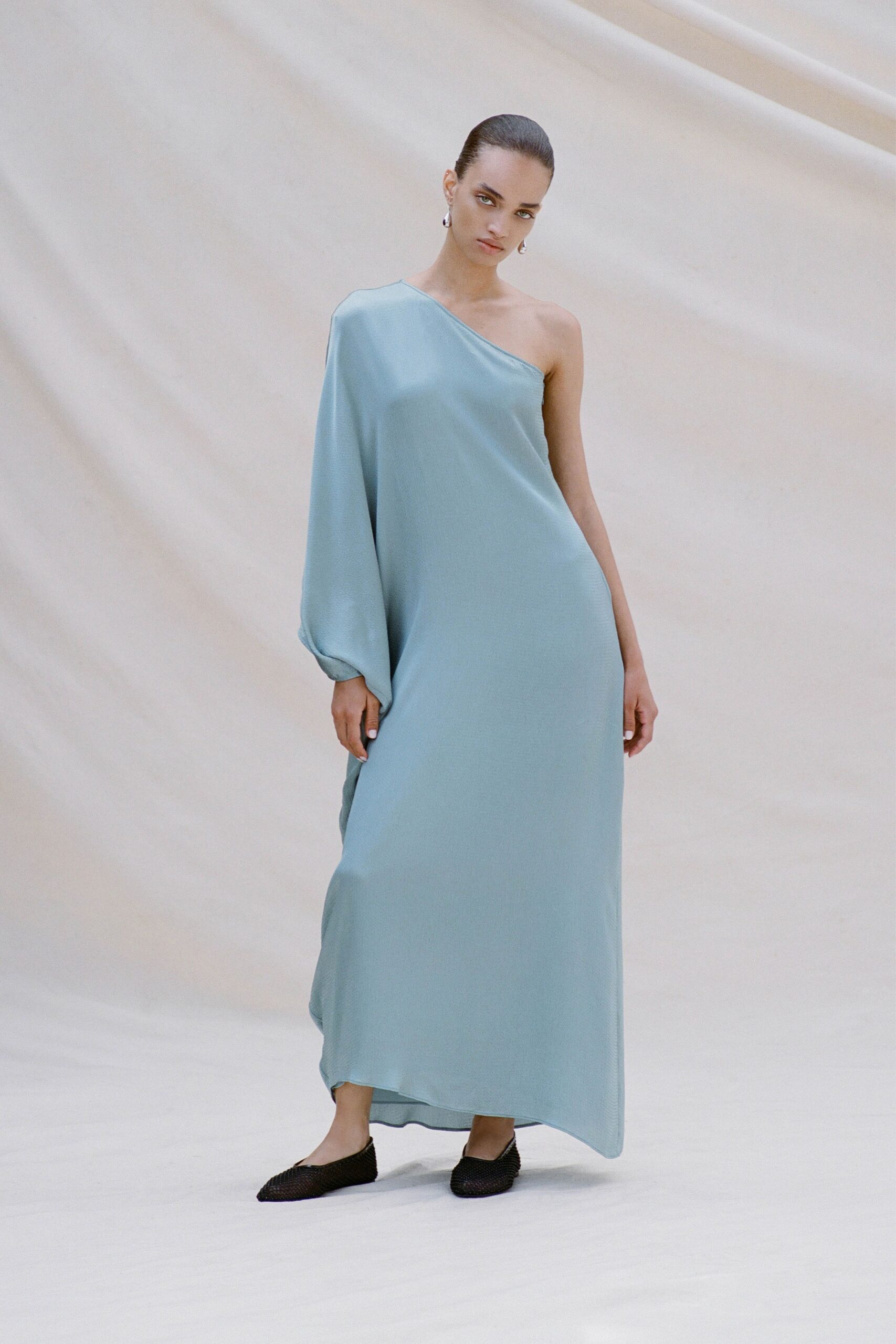 blue silk sleeveless asymmetric fitted draped flowing gown