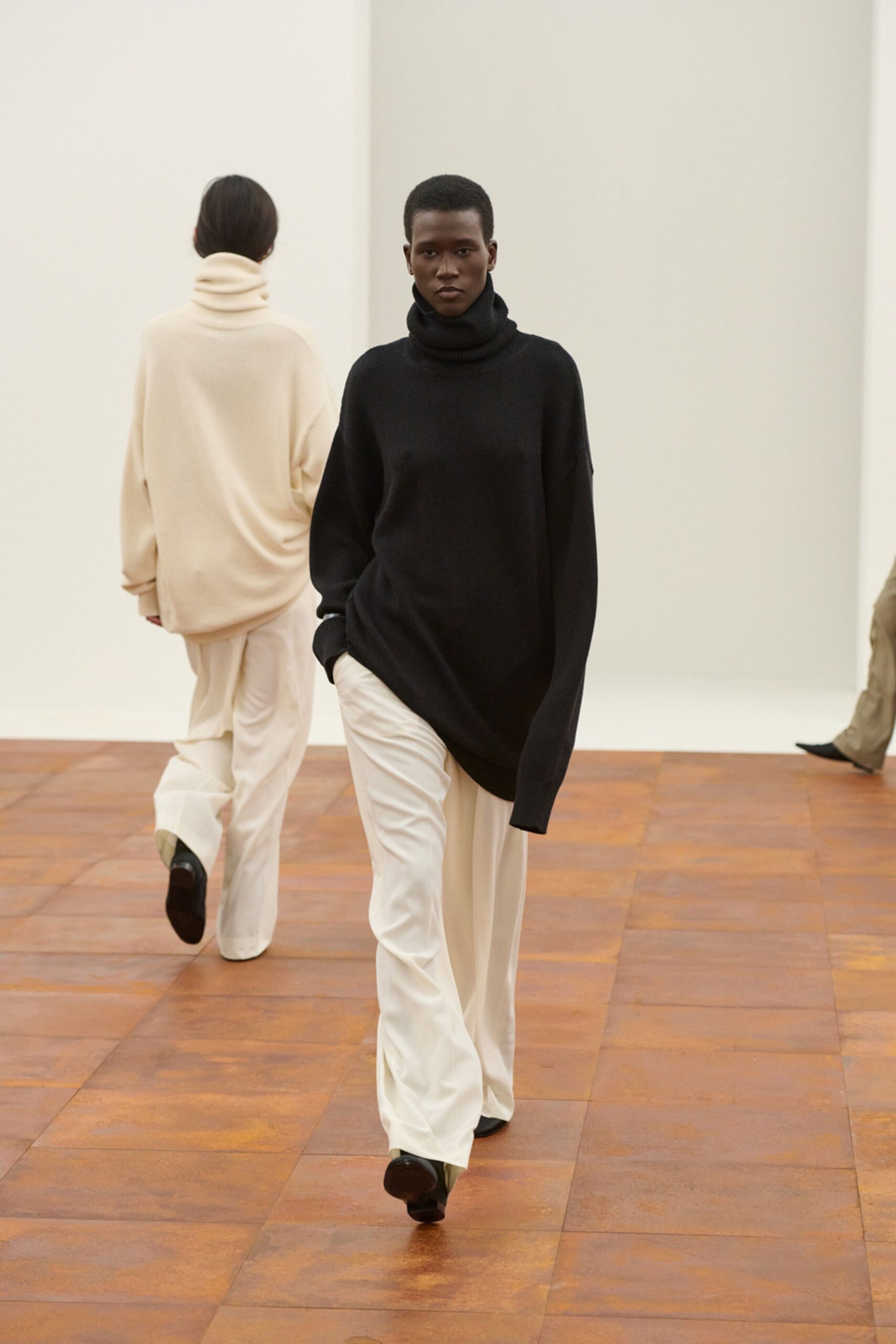 black oversized sweater and white pants