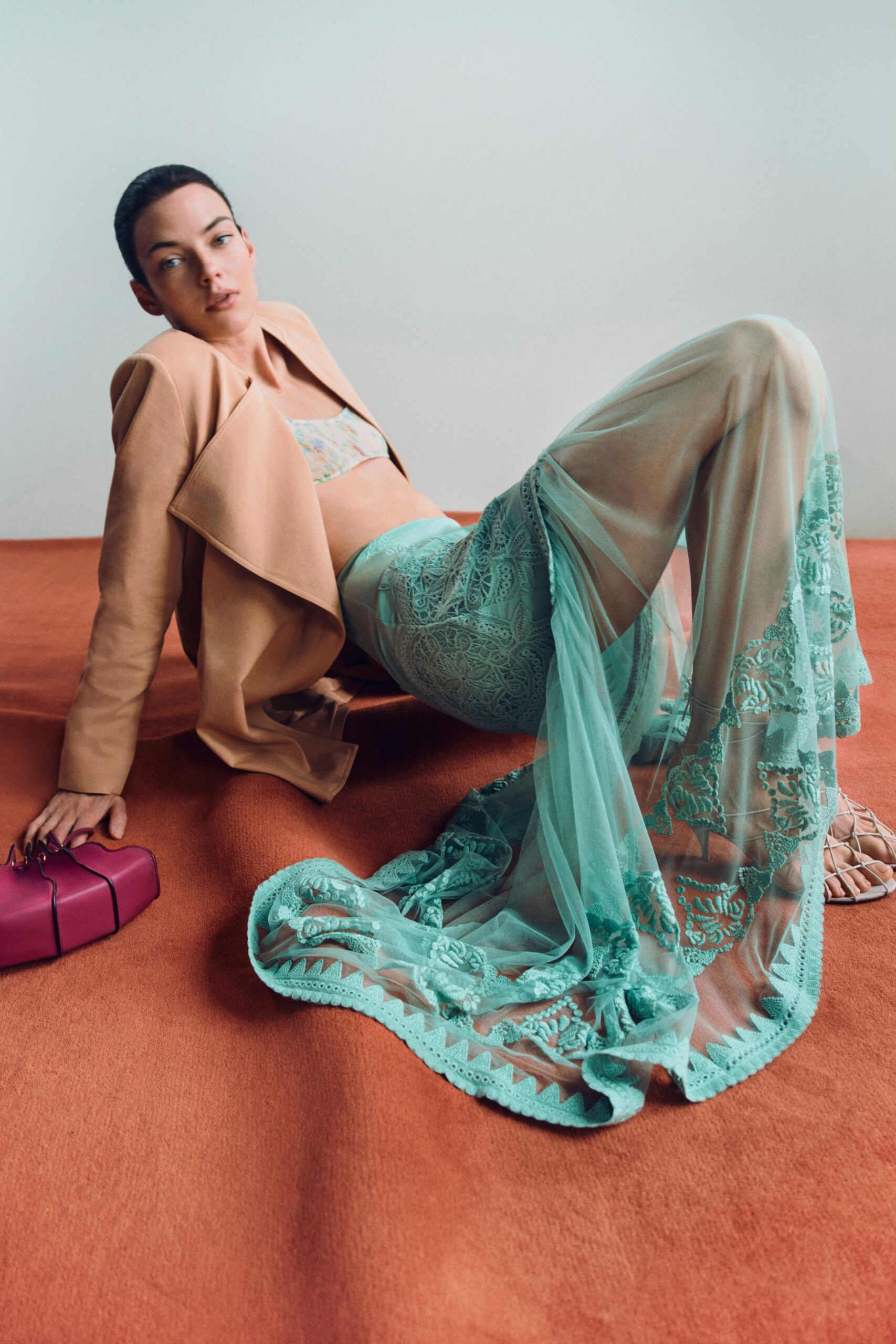 beige jacket with teal sheer pants