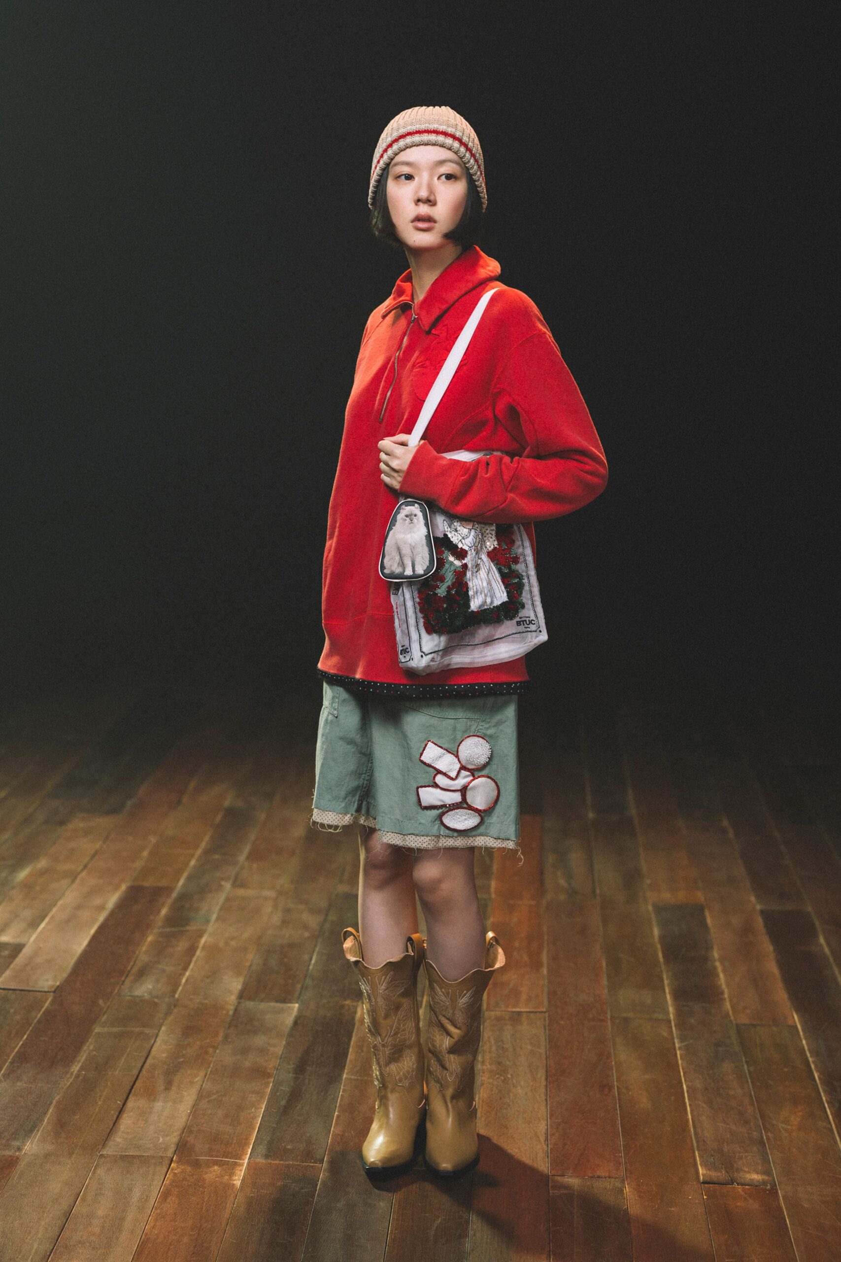 red relaxed top with green shorts