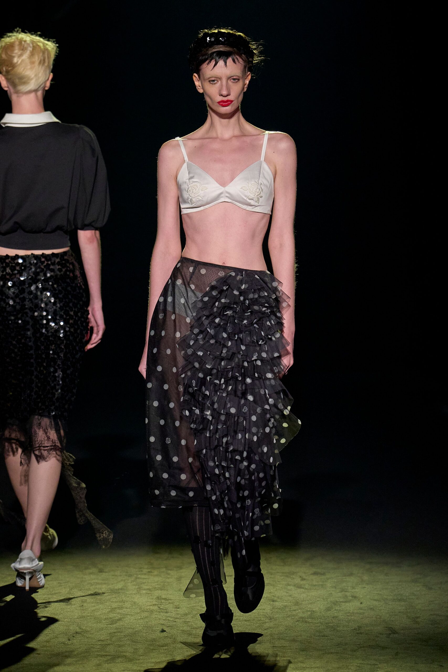 white lace bra and black polka-dot skirt