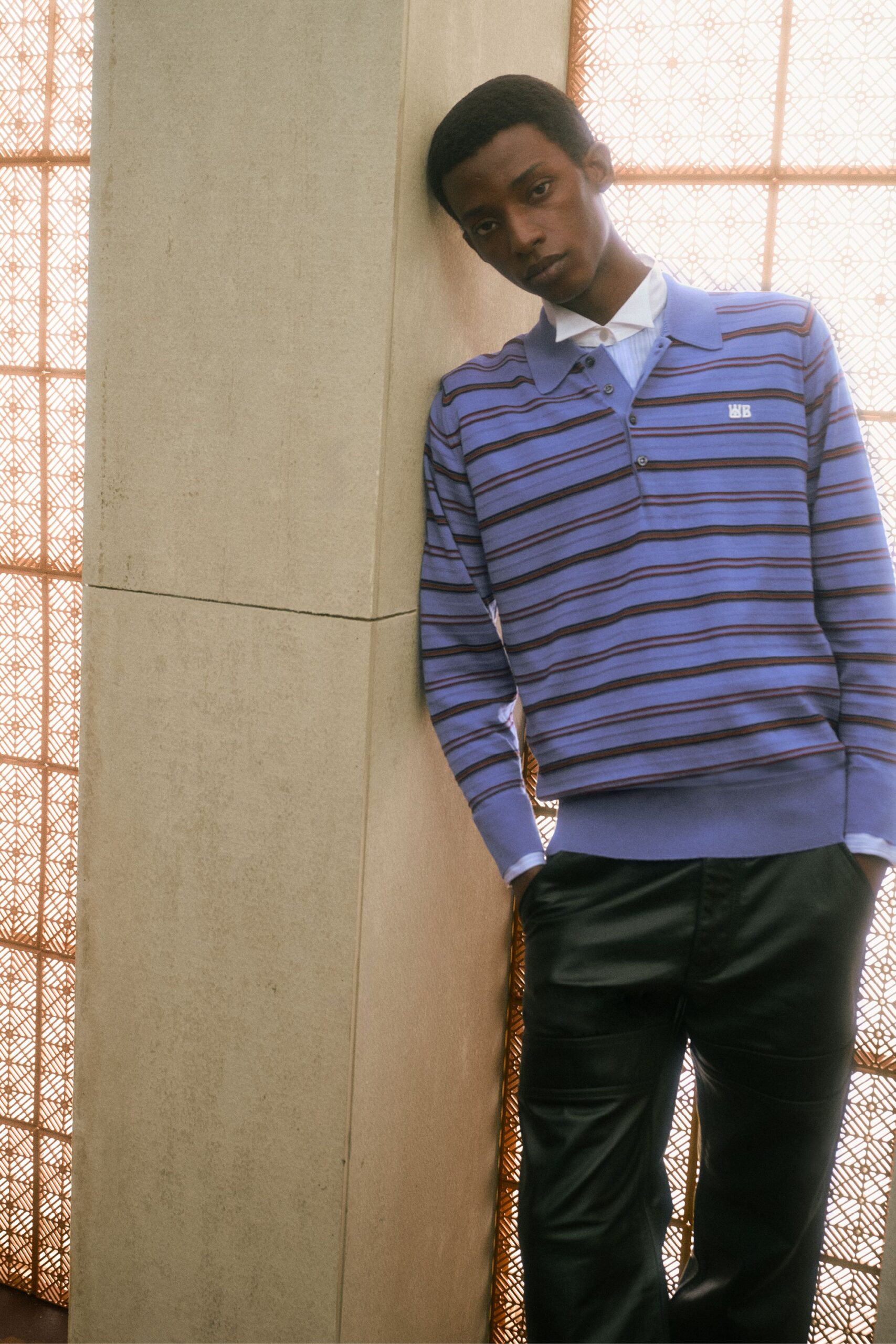 blue striped fitted sweater and black leather pants
