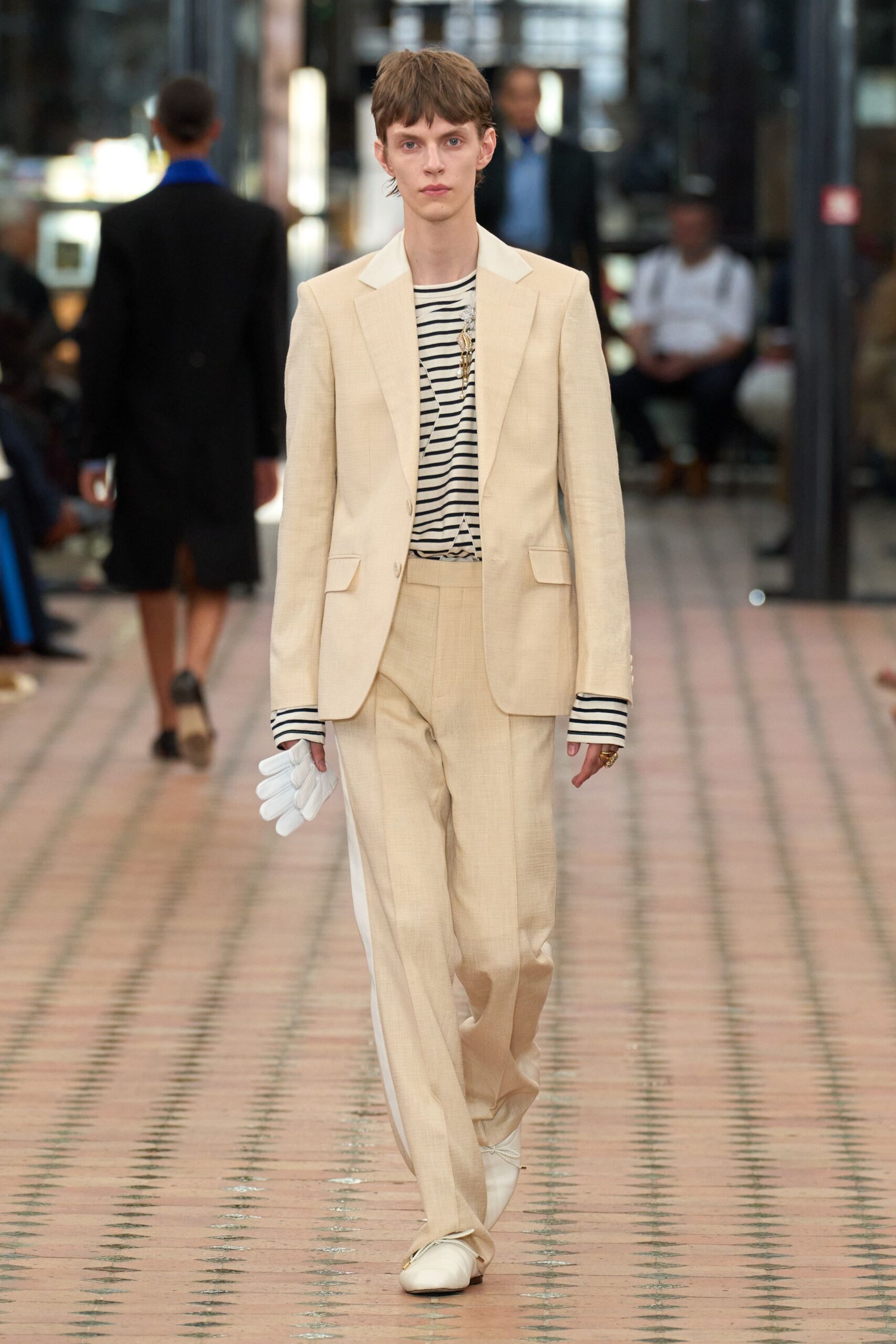 beige tailored suit with striped shirt