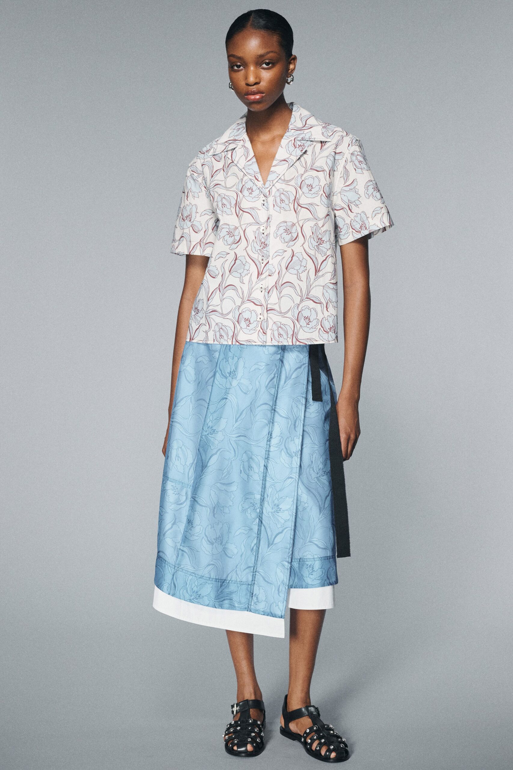 printed top with blue skirt
