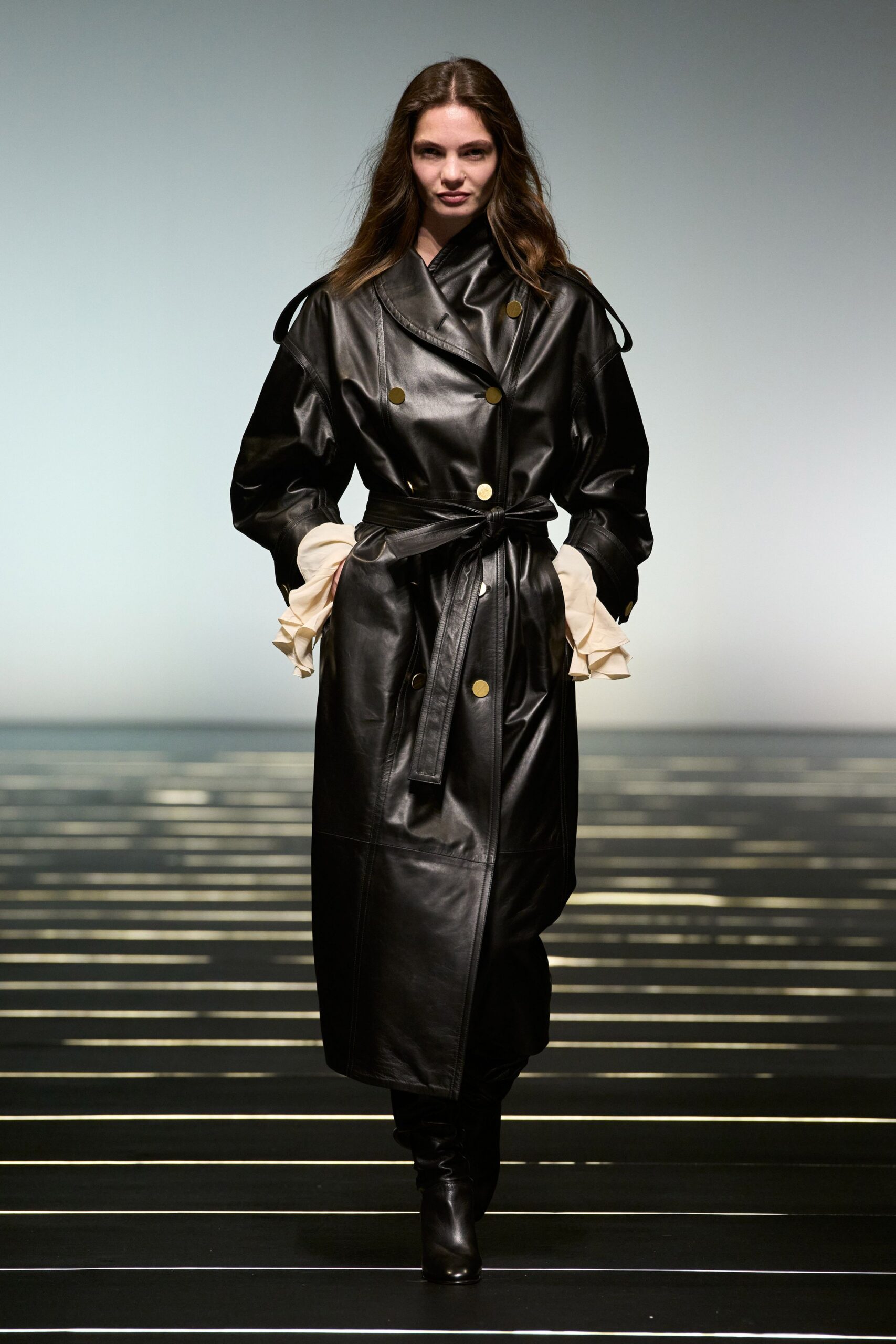 black leather coat with beige gloves