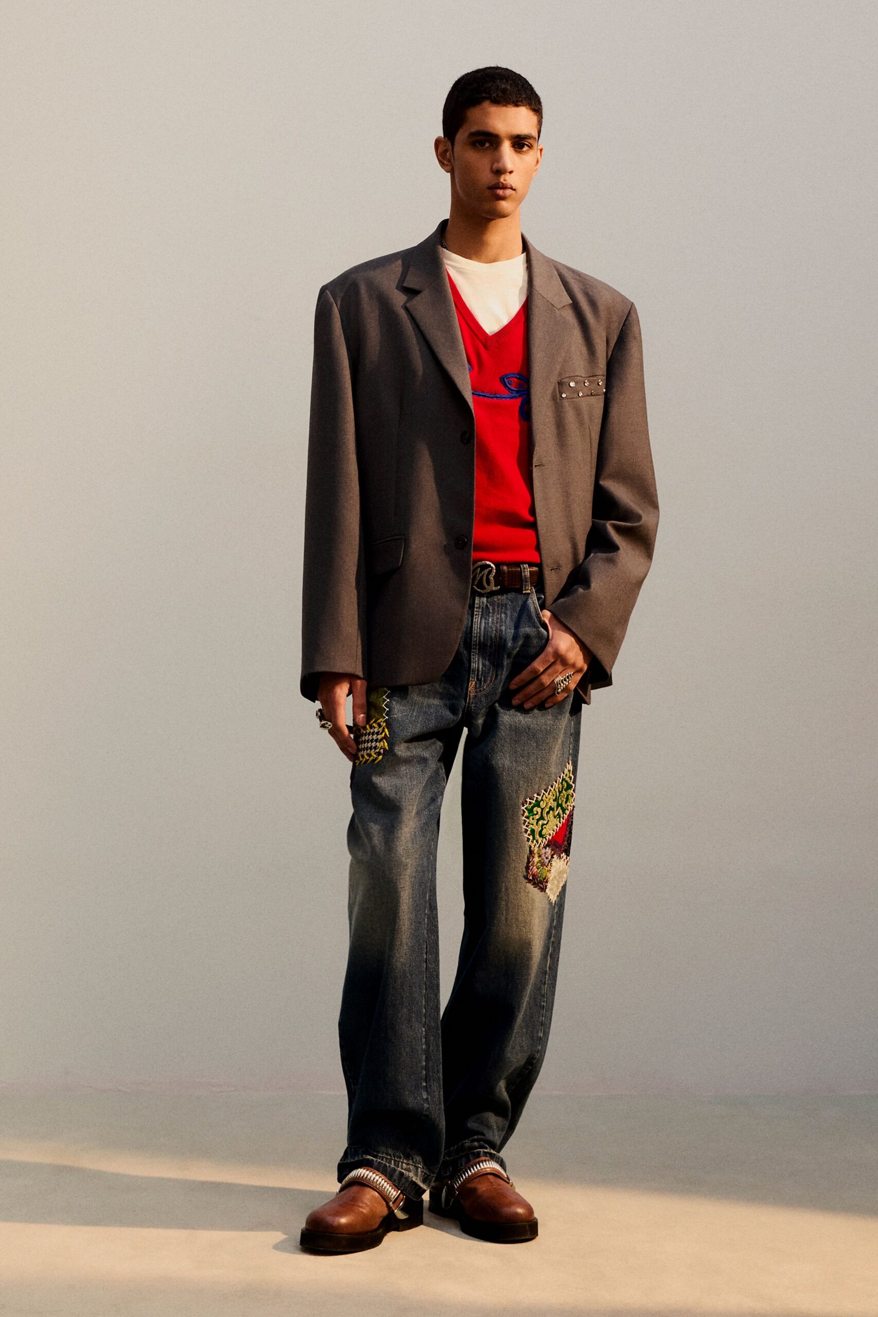 gray blazer red sweater denim pants