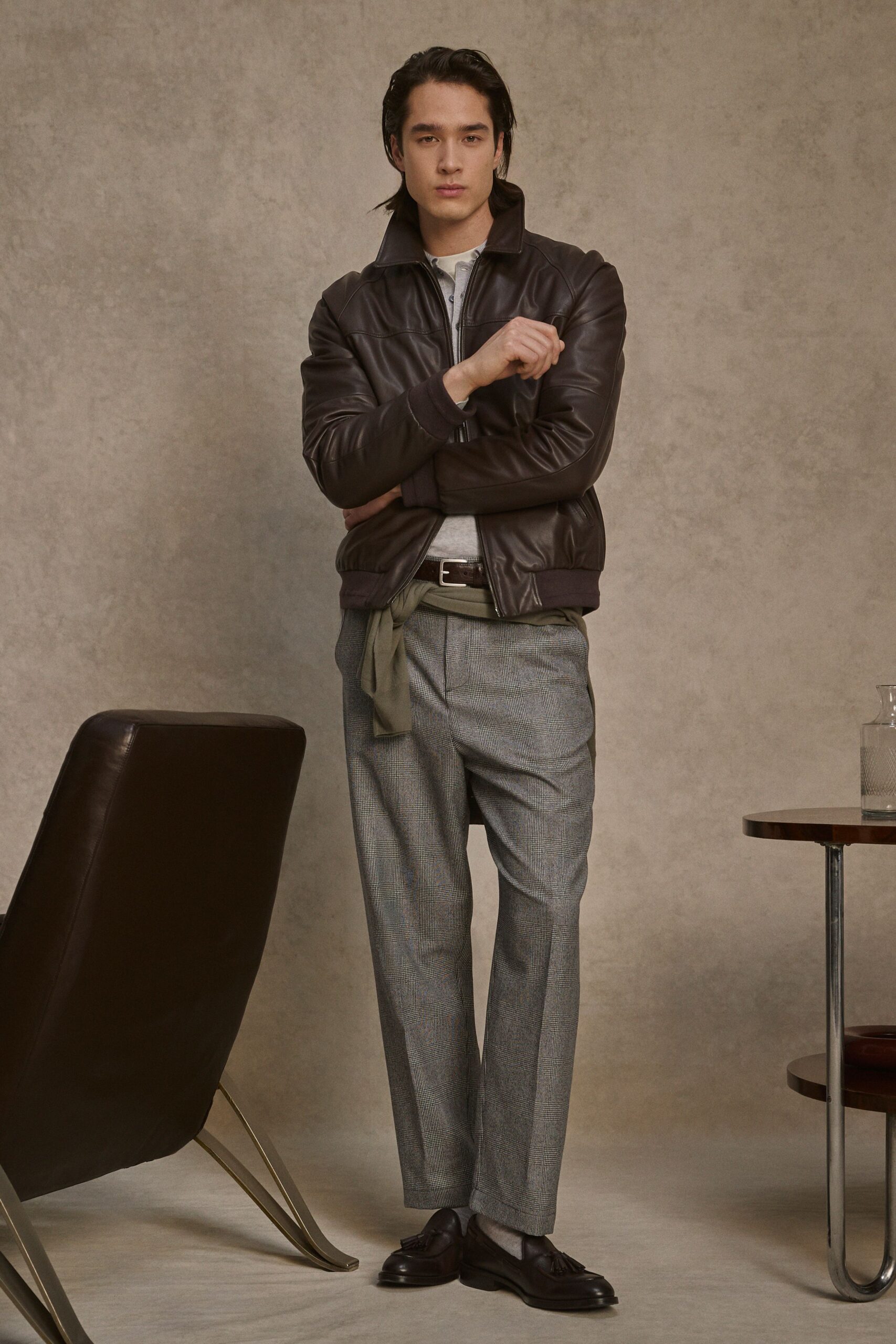 brown leather jacket with gray pants