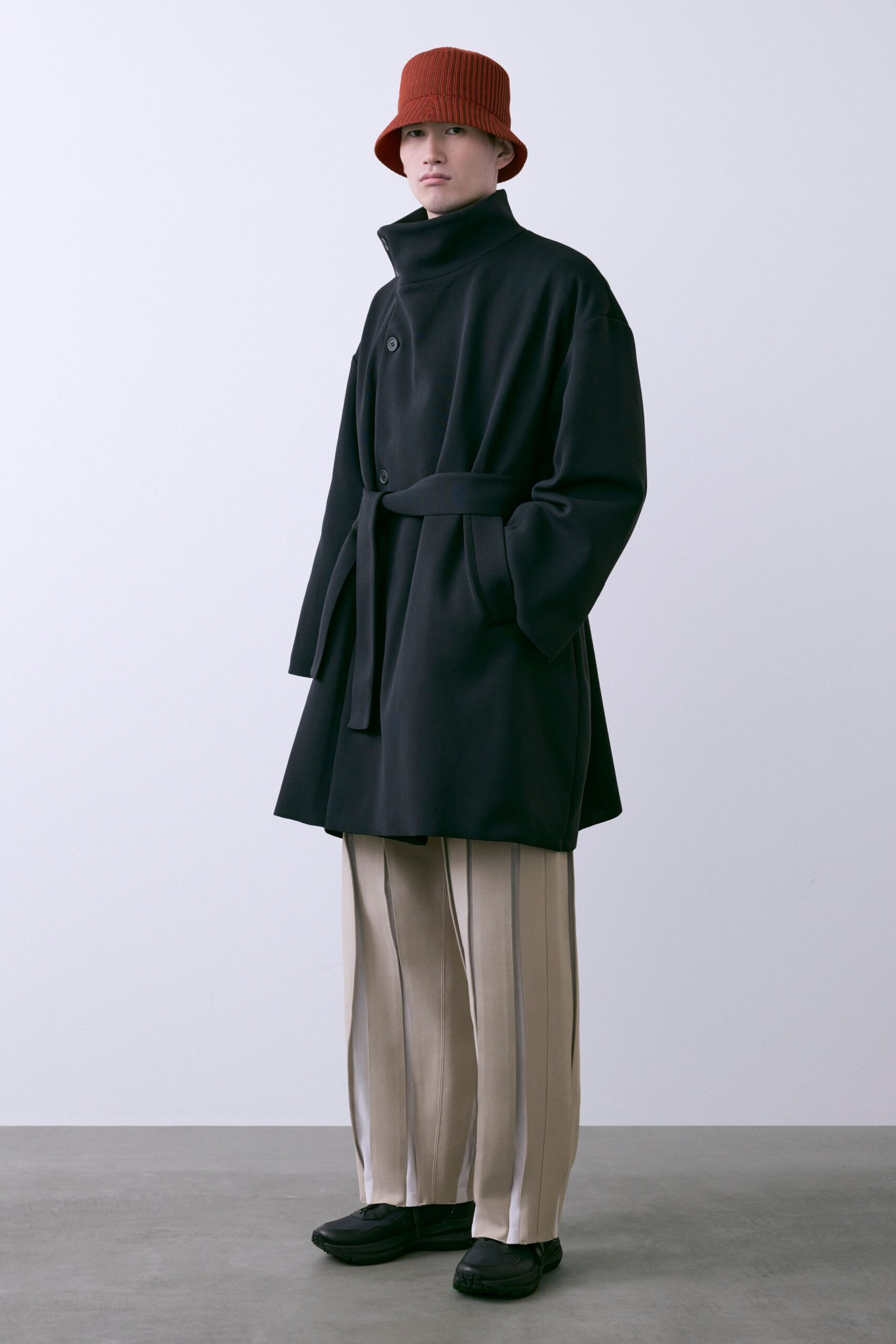 black wool coat with beige pants