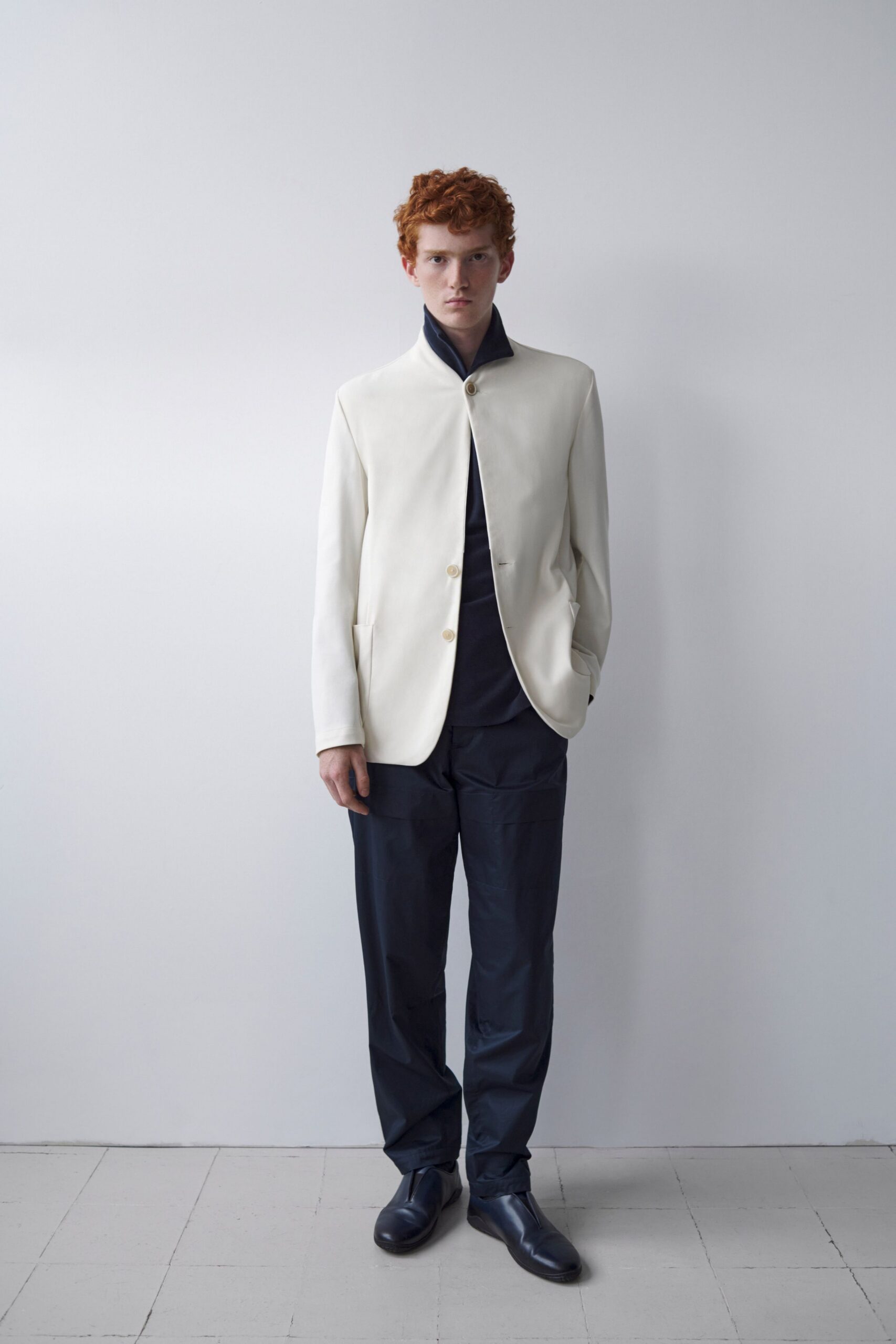 white blazer black shirt navy pants