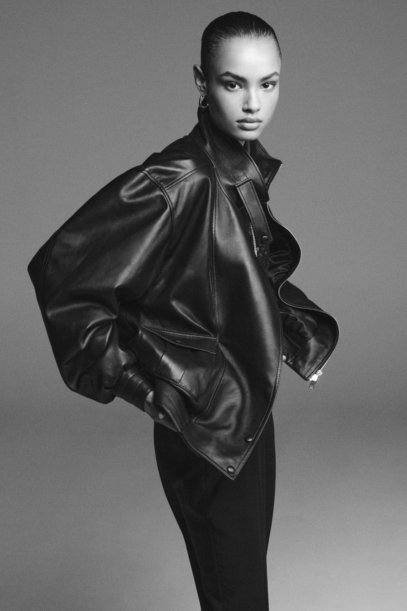 black leather oversized jacket and fitted pants