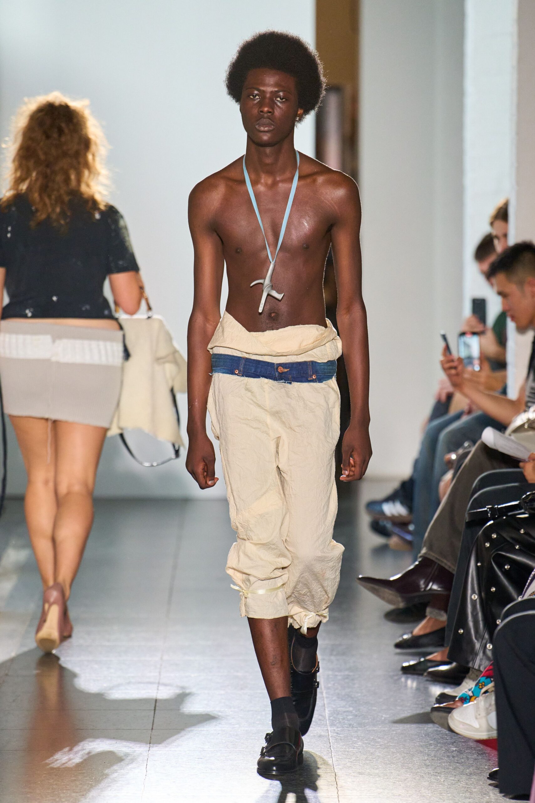 beige relaxed pants with black shoes