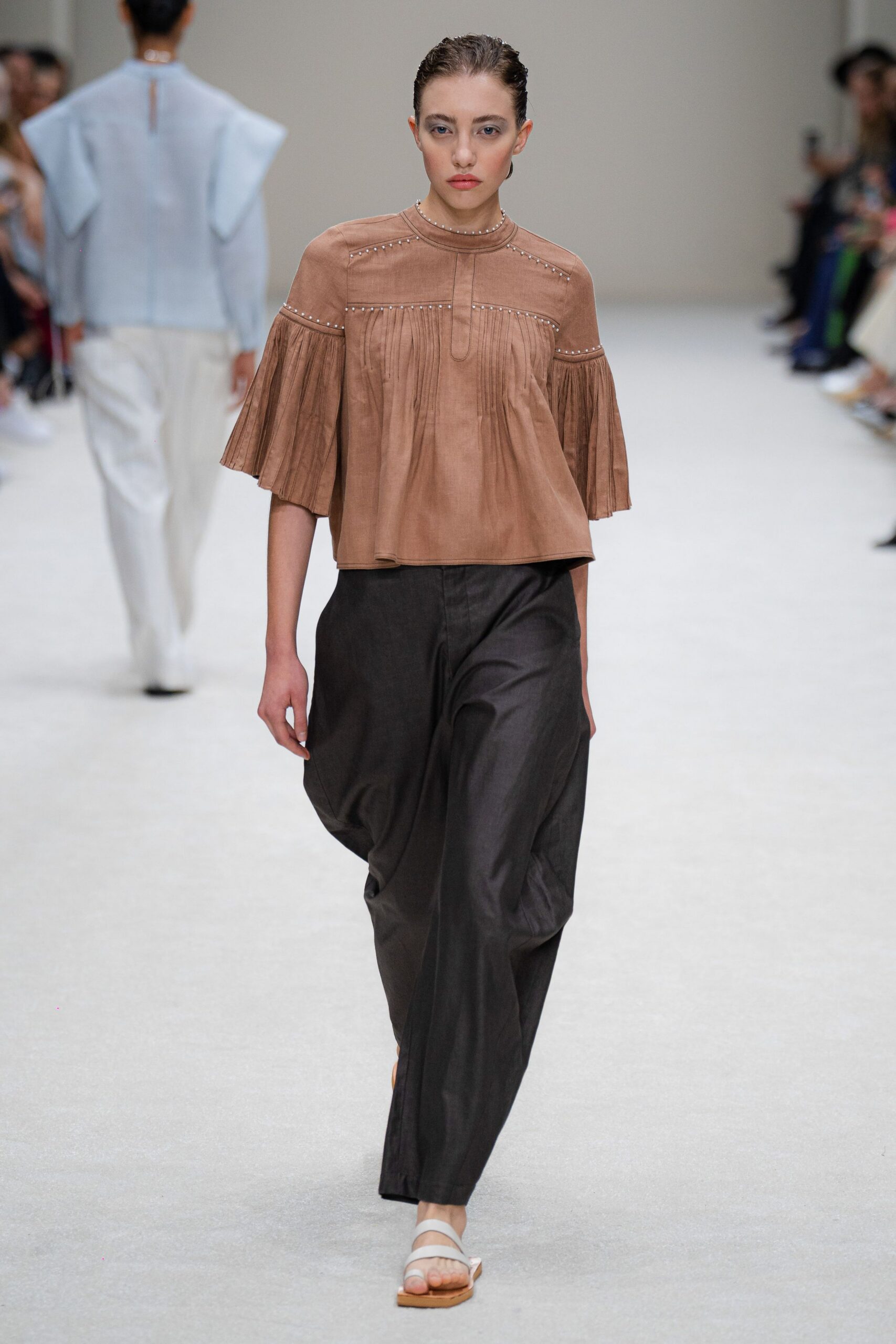 brown relaxed top with black pants