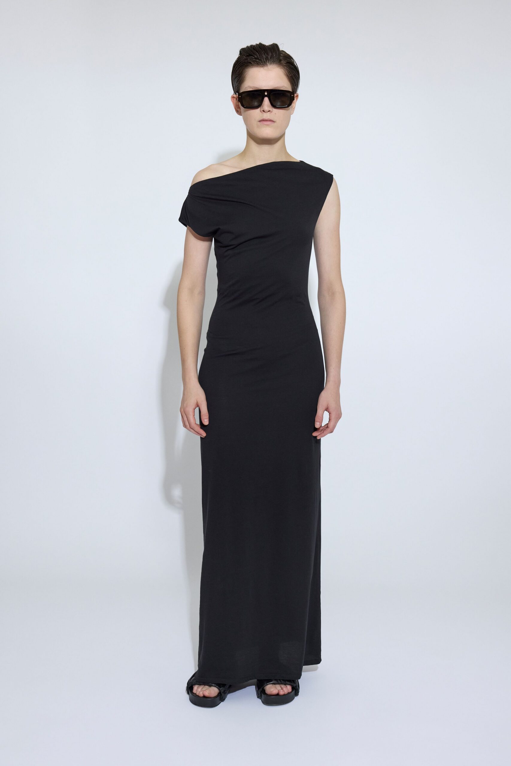 black cotton sleeveless off-shoulder fitted flowing maxi gown
