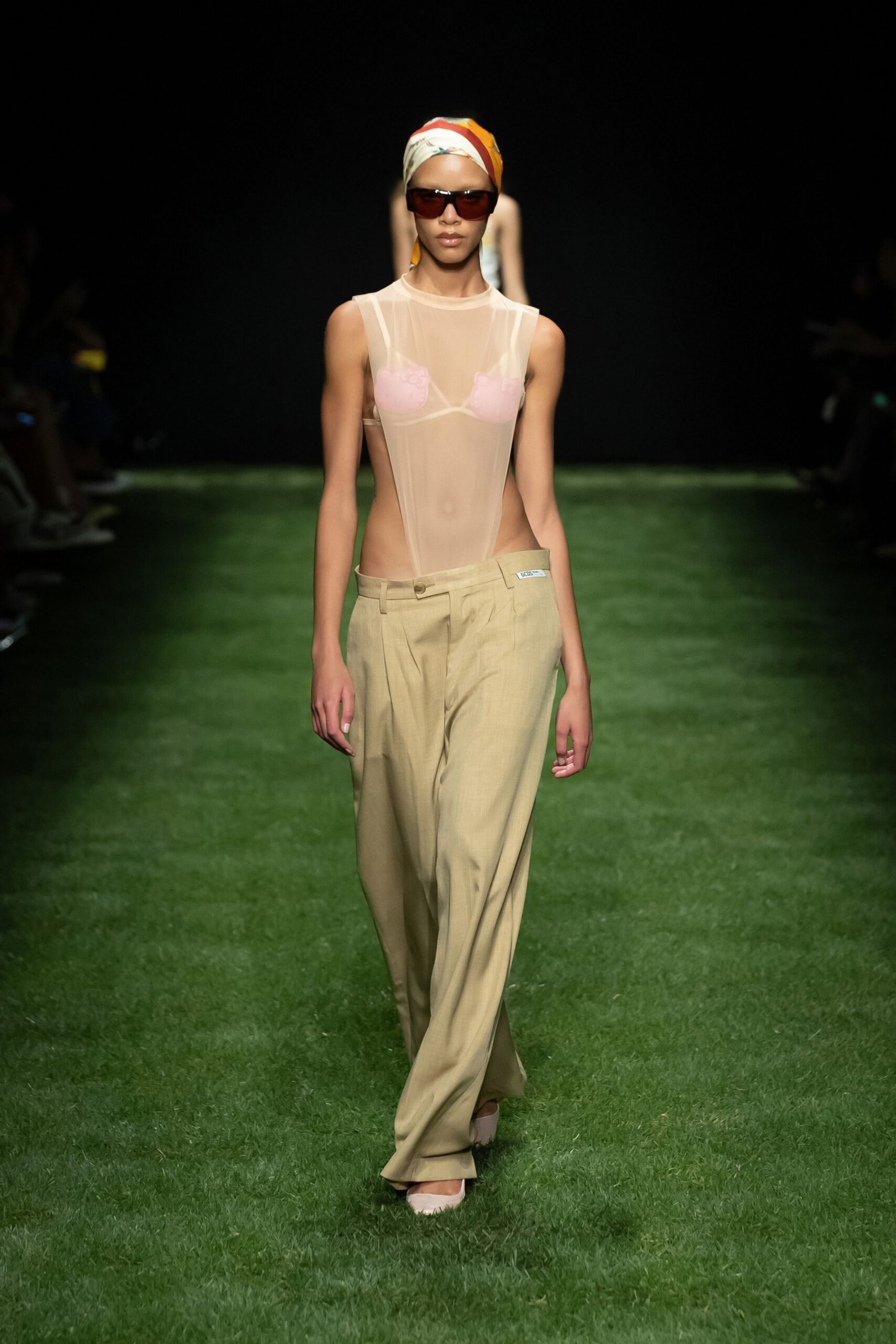 sheer pink top with beige pants