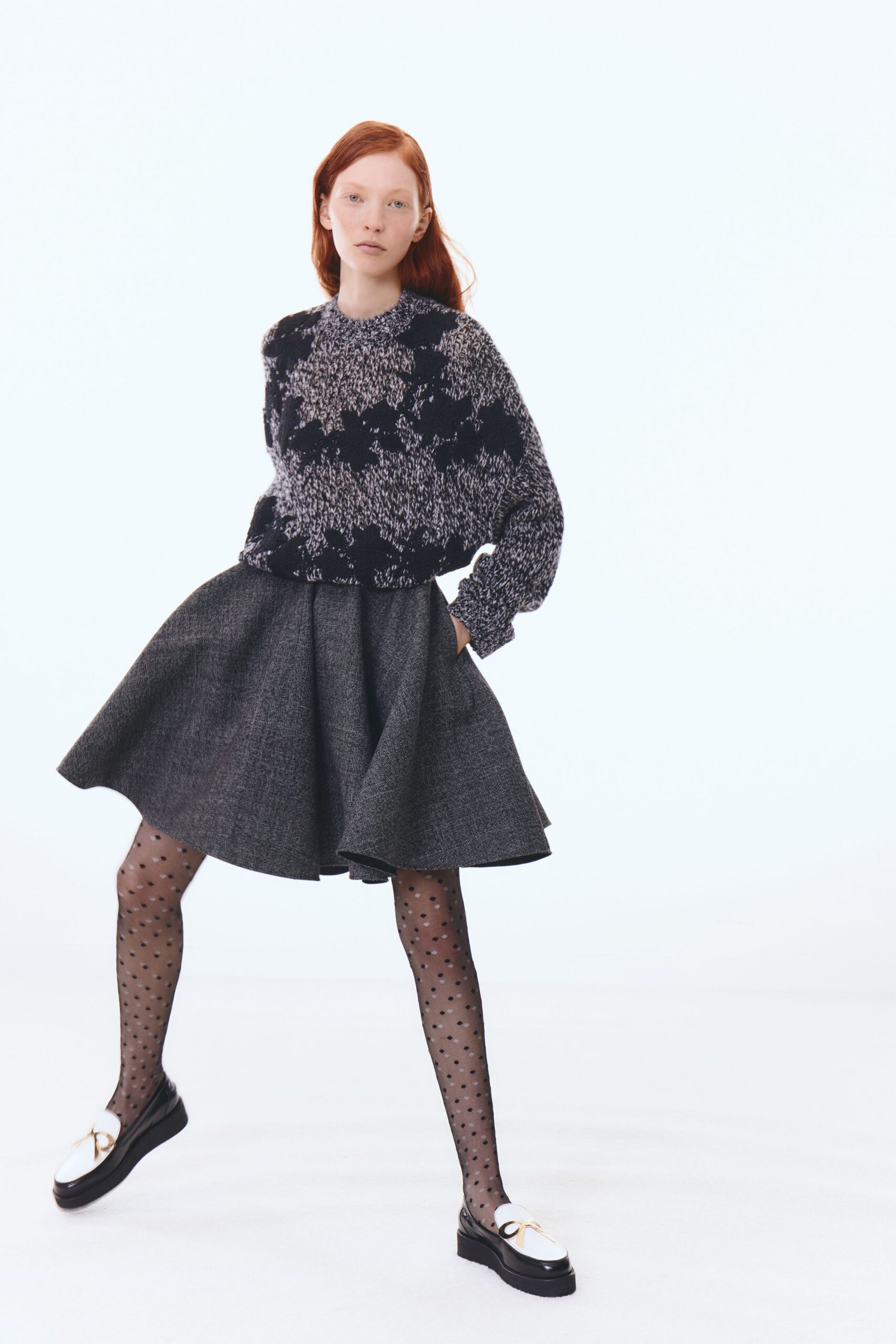 black and white printed sweater with gray skirt
