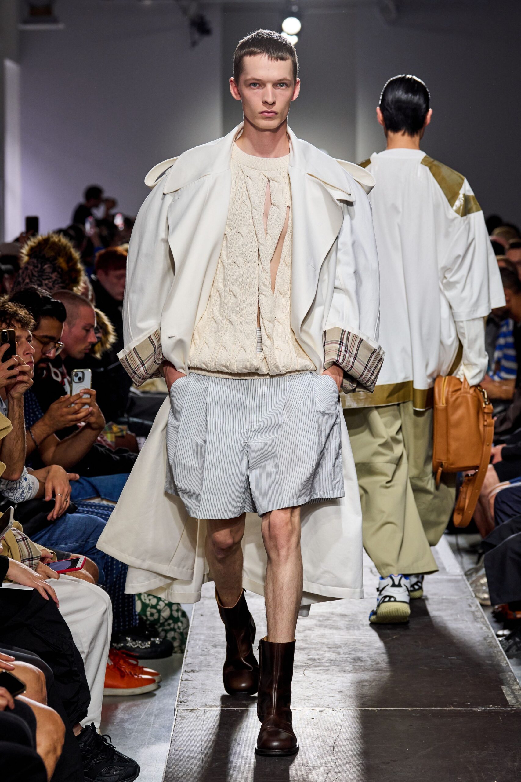 white coat beige sweater blue shorts