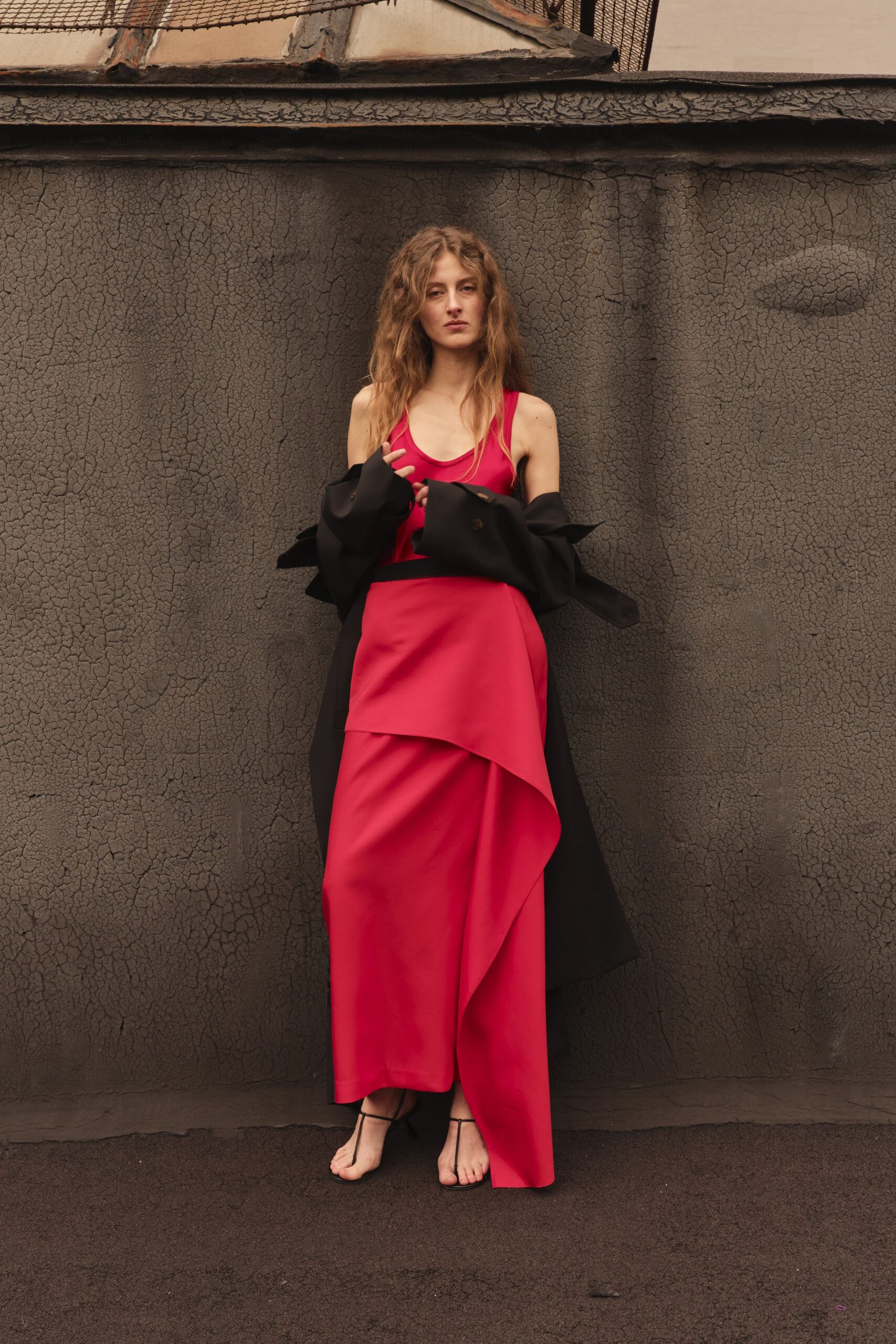red silk sleeveless dress with black coat