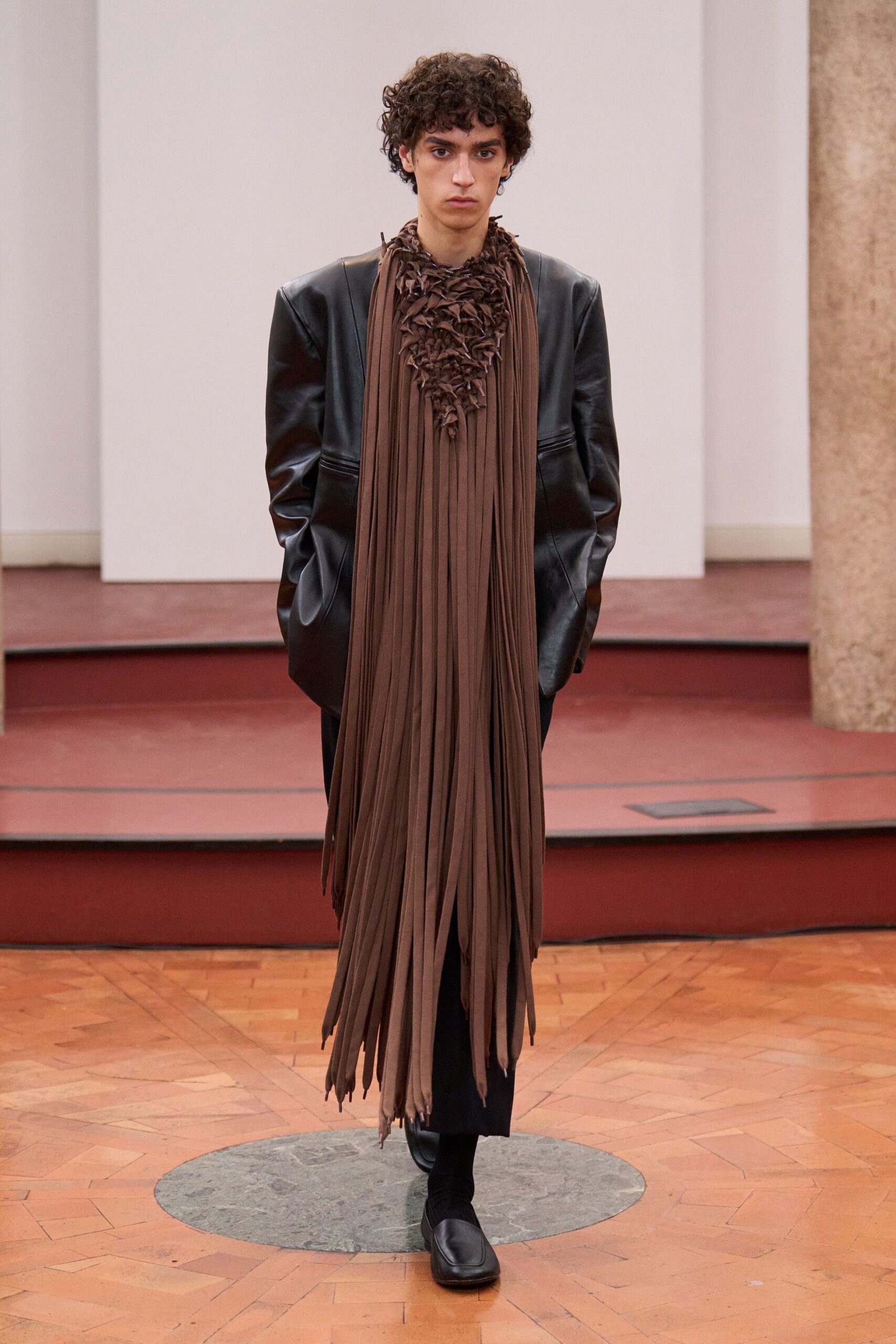 black leather oversized coat with fringed scarf