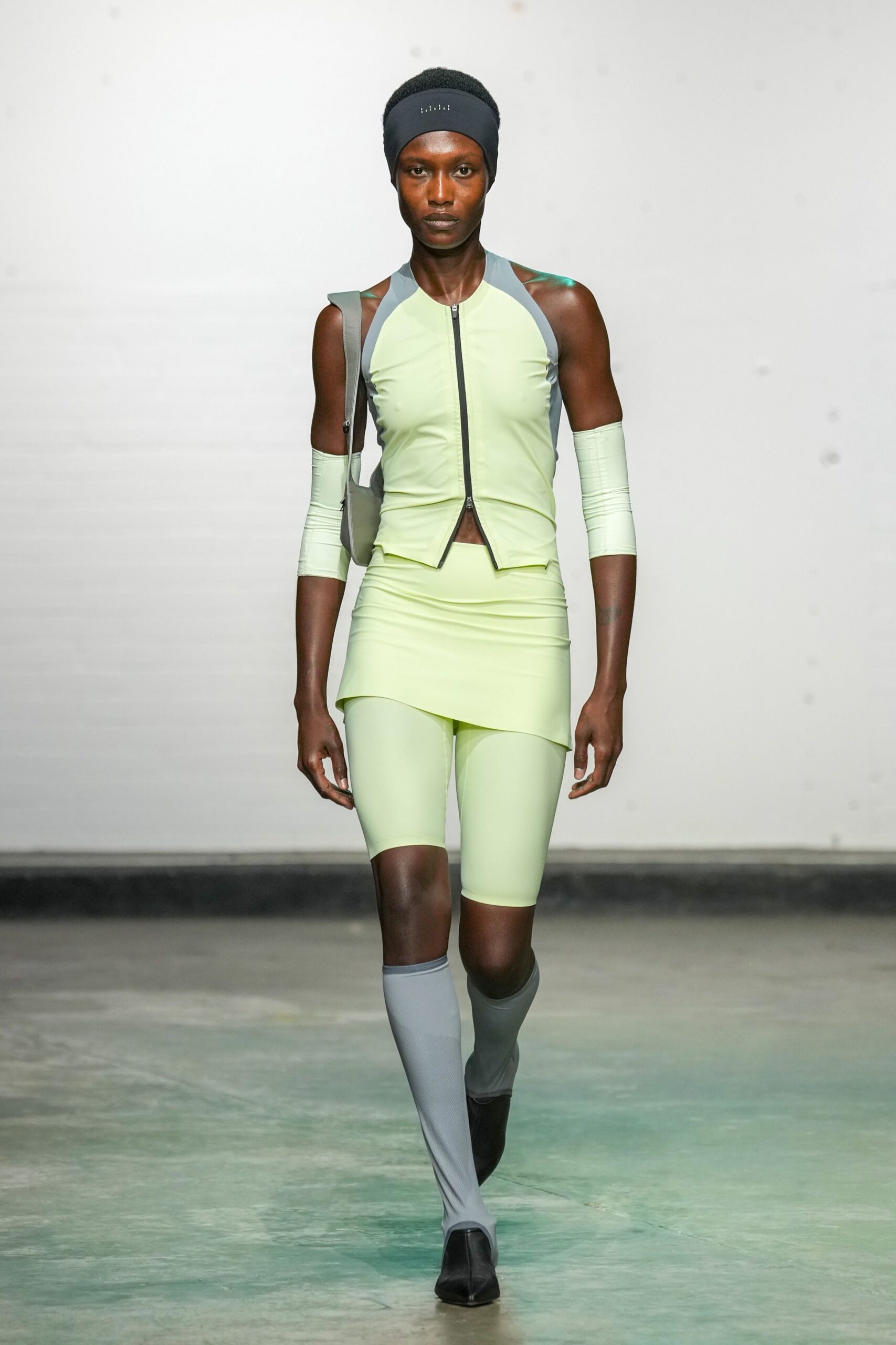 green neoprene sleeveless high-neck fitted zippered top