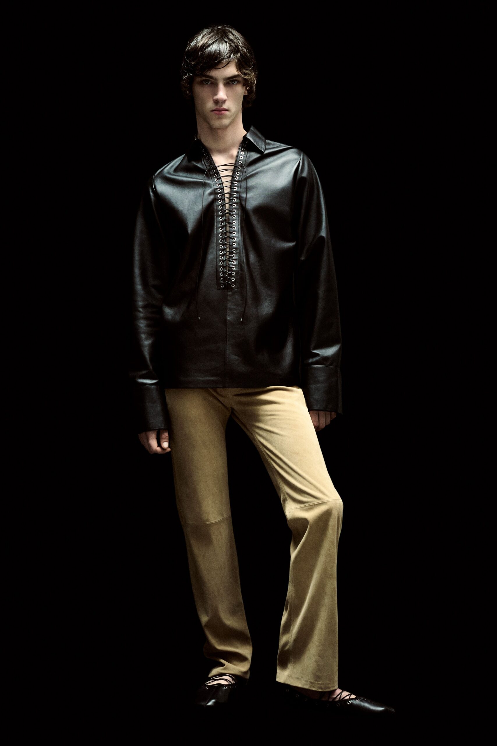 black leather shirt beige pants