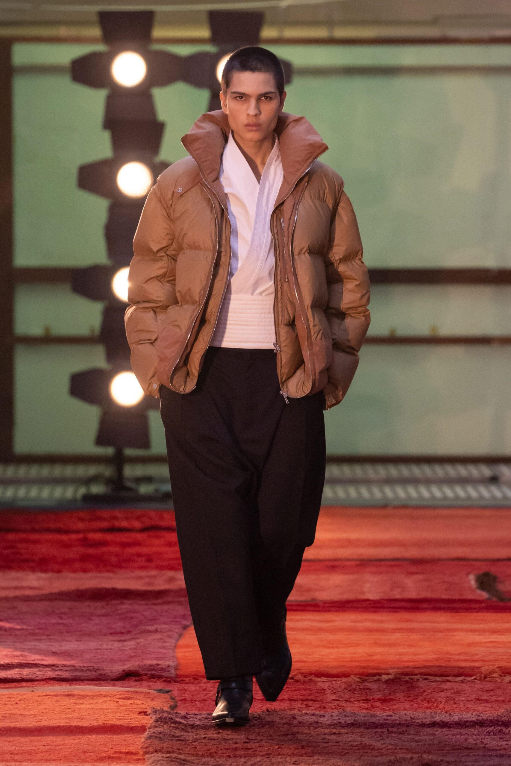 brown puffer jacket with black pants