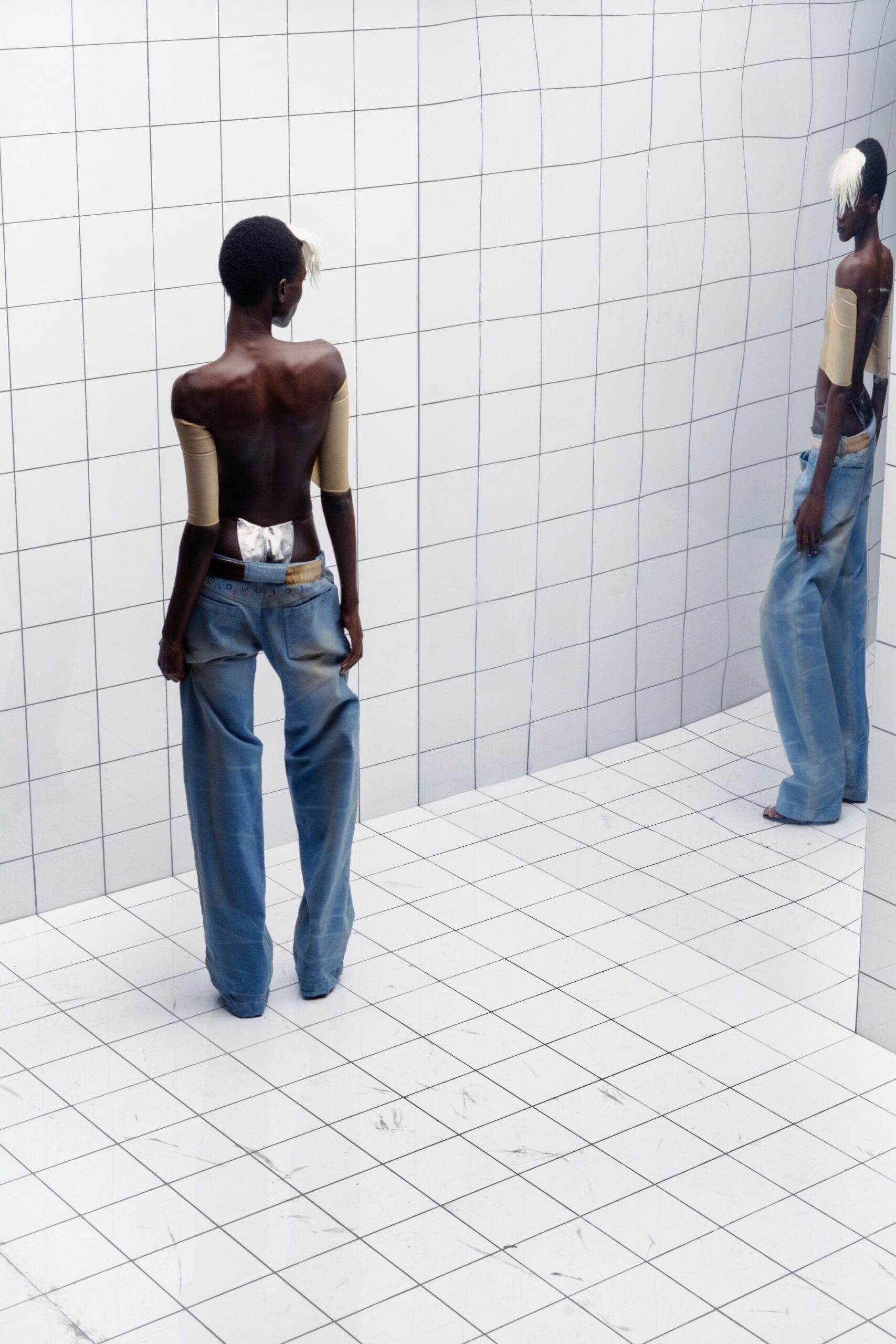 relaxed blue denim pants and fitted beige top
