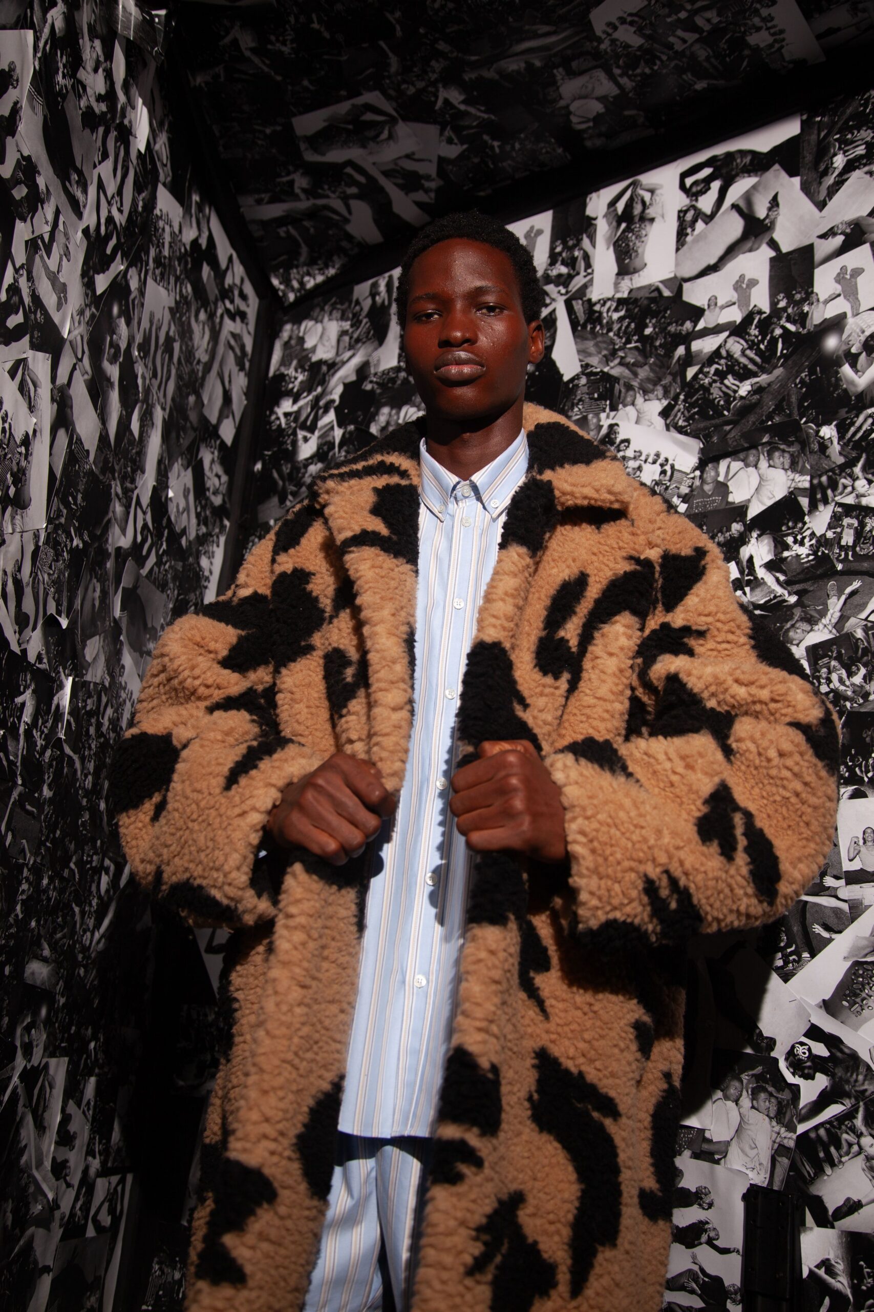 brown black faux-fur coat and blue striped shirt