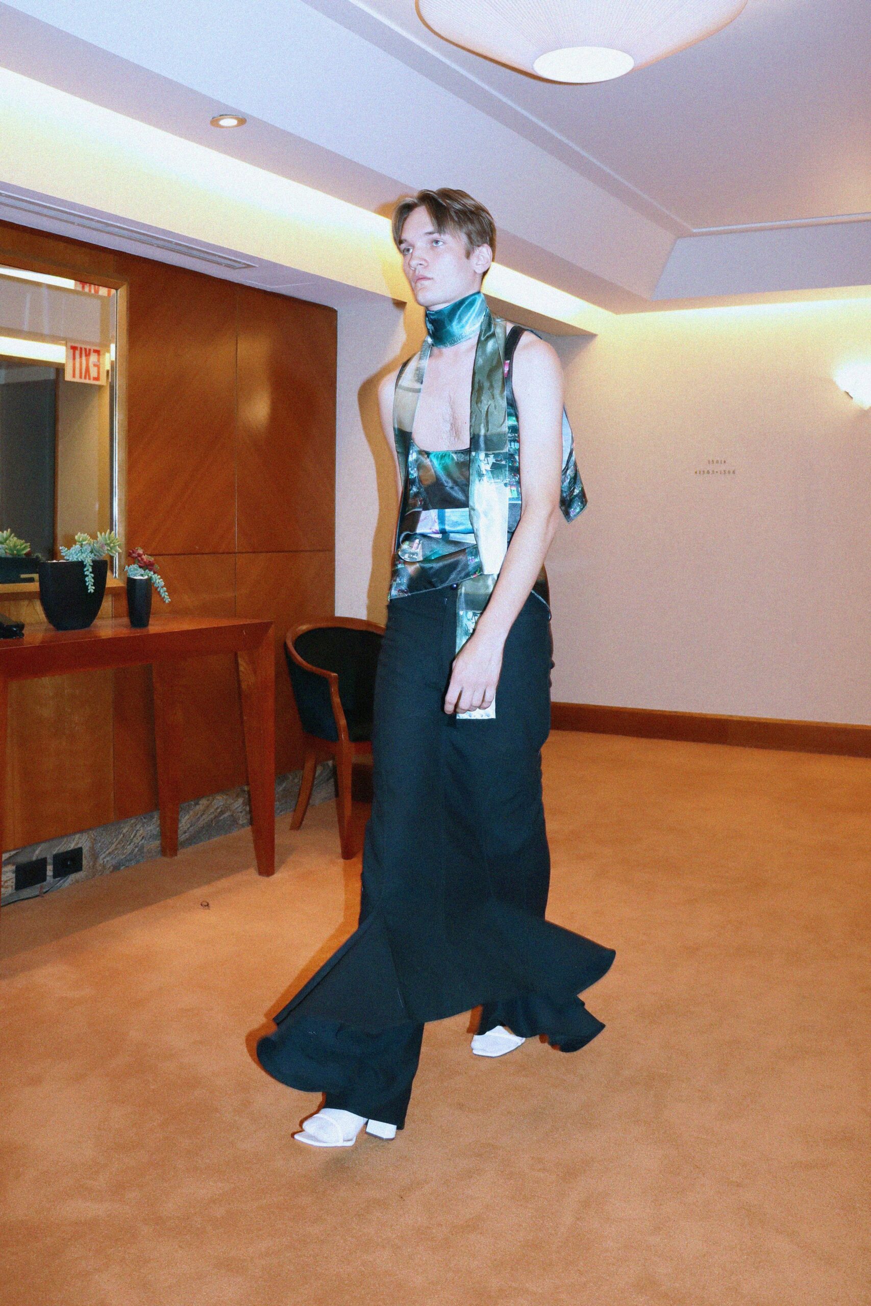 fitted blue green silk top with flared black pants