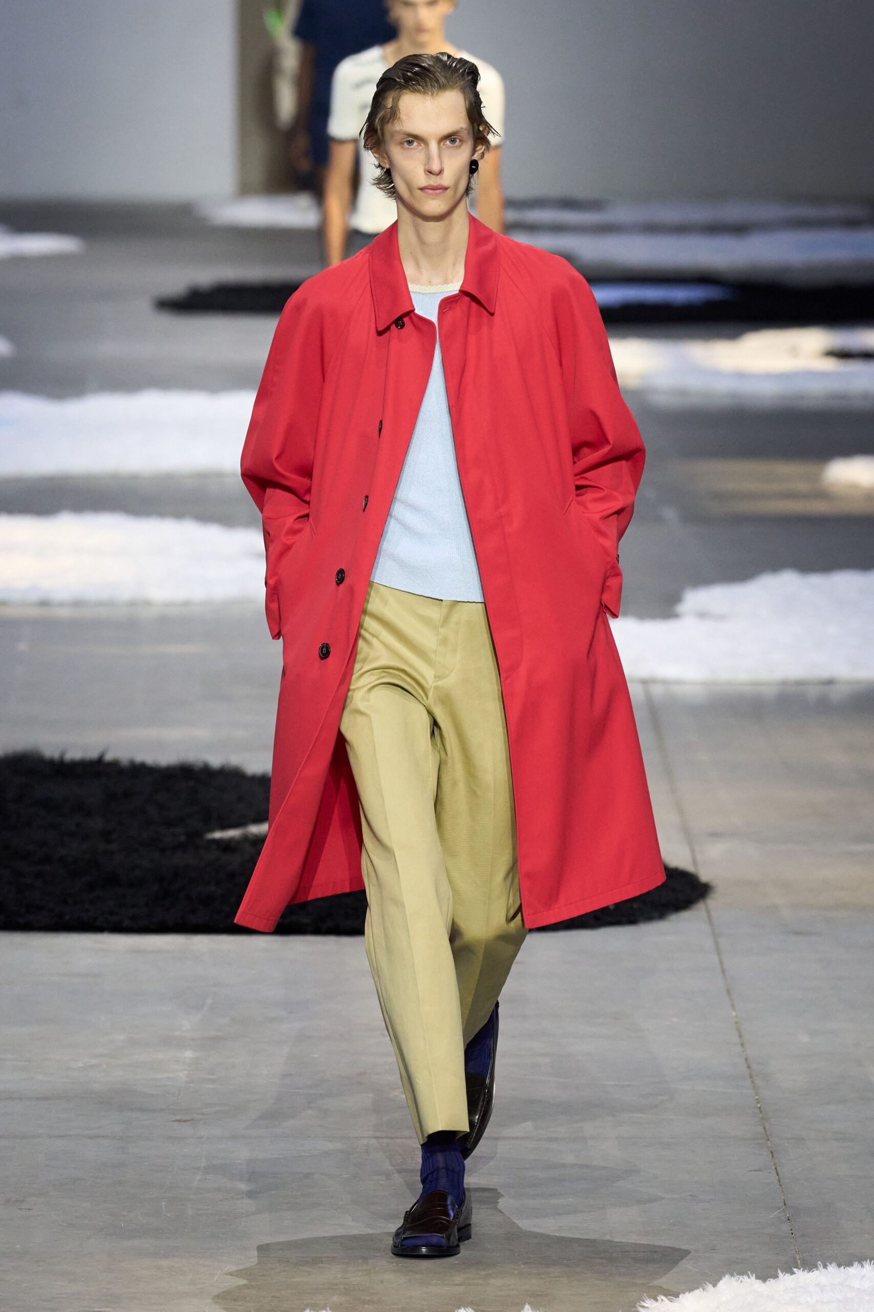 red coat blue sweater beige pants