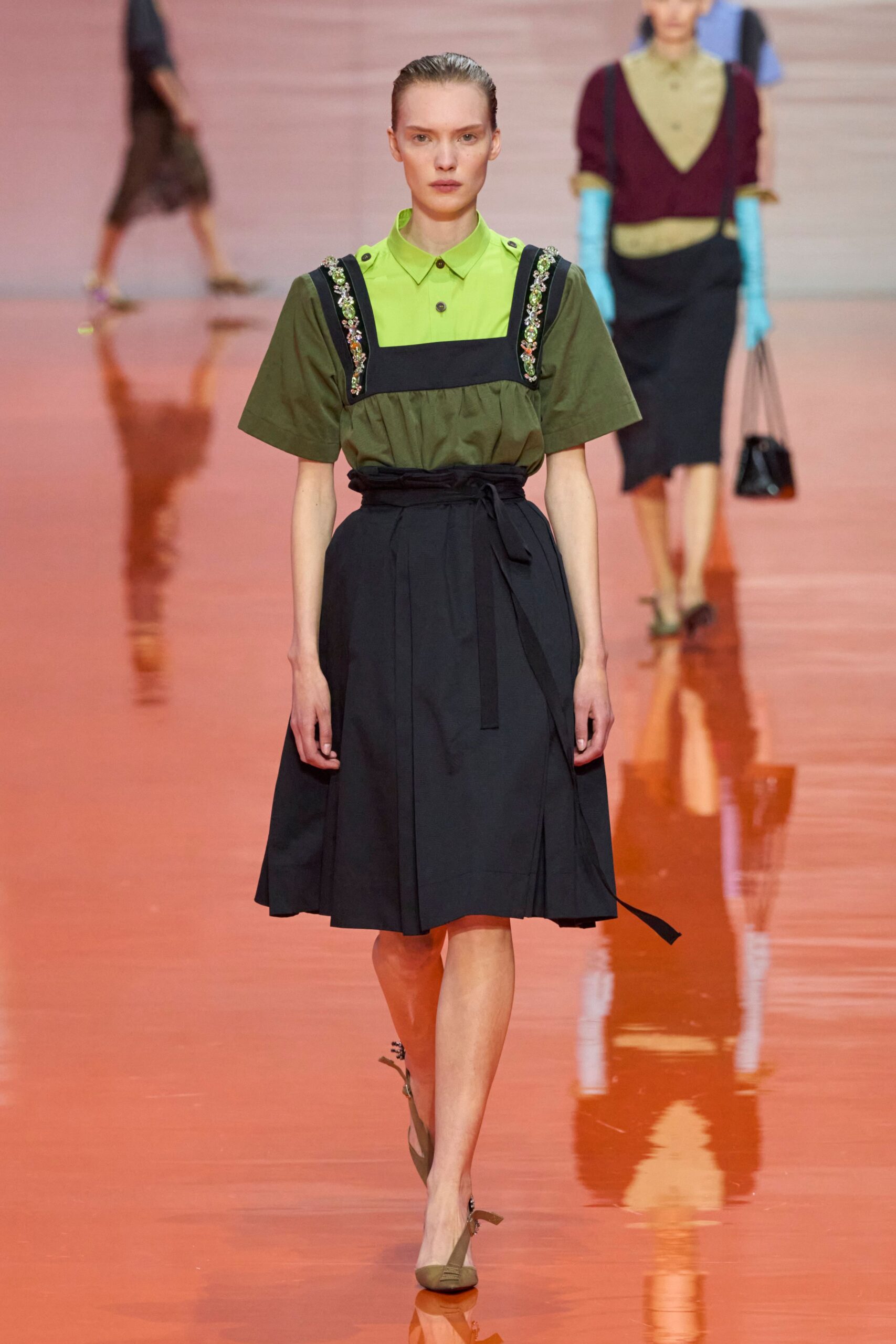 green collared shirt black pleated skirt