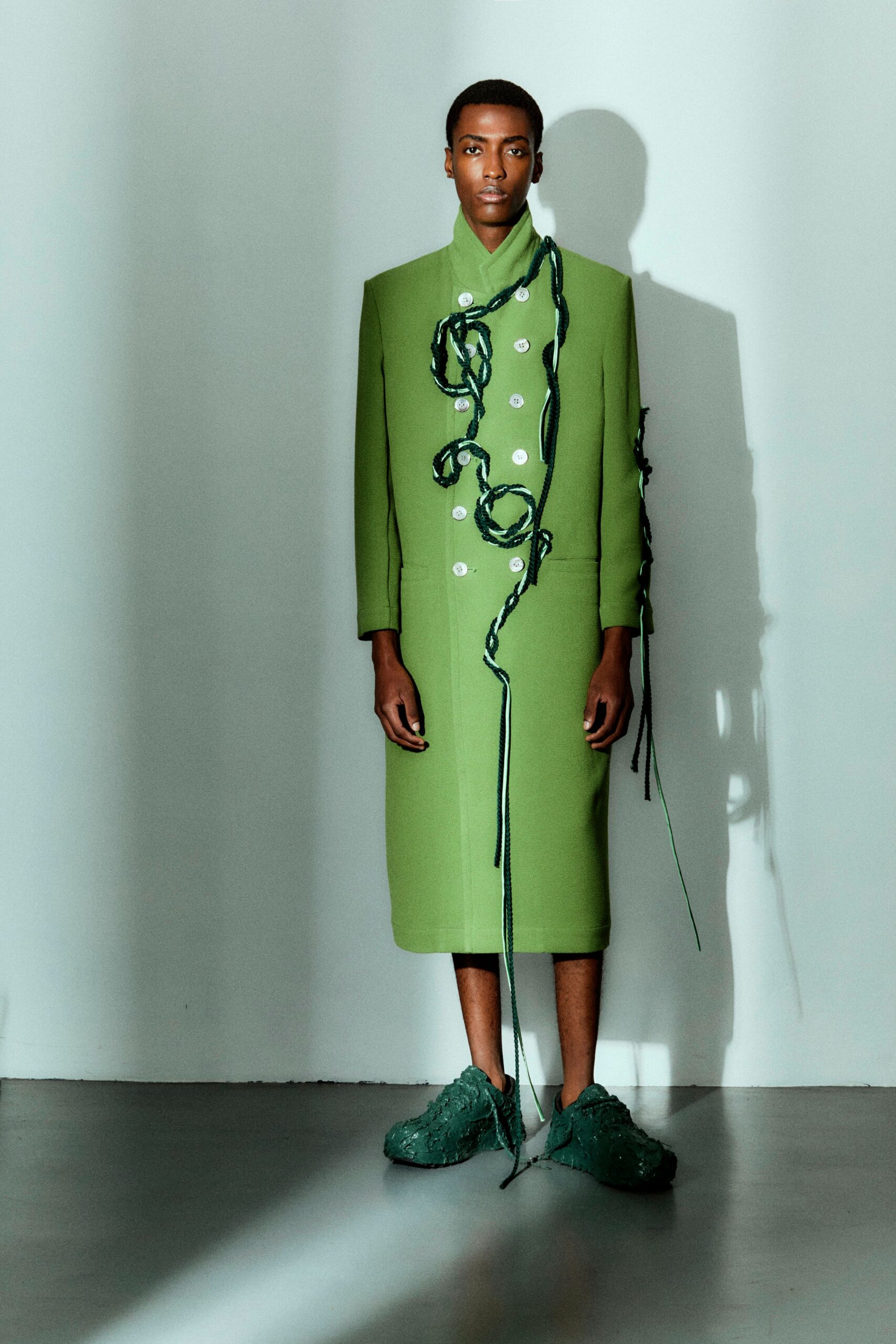 green cotton long-sleeve collared fitted buttoned draped coat