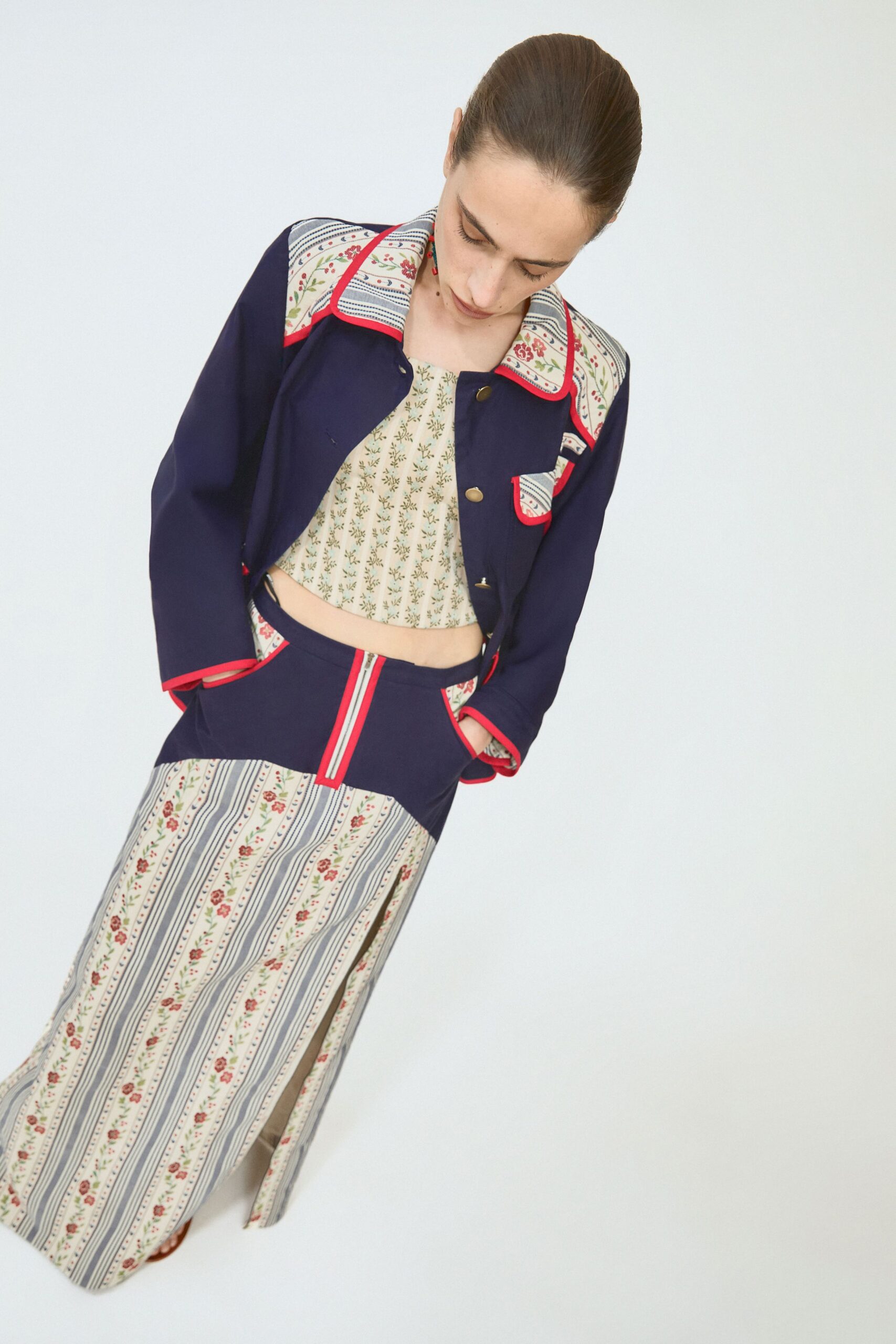 navy jacket with floral top and striped skirt