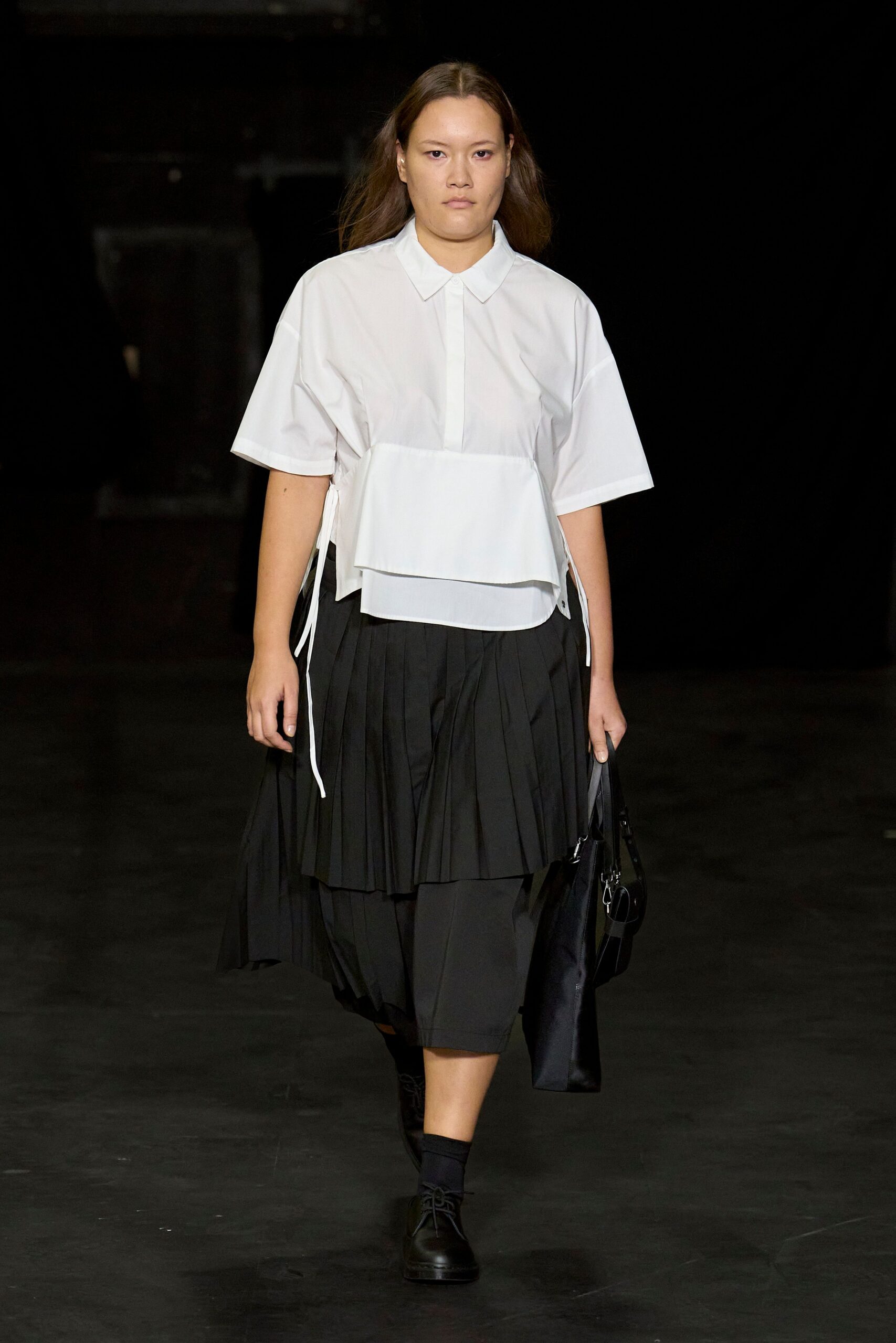 white relaxed shirt with black pleated skirt