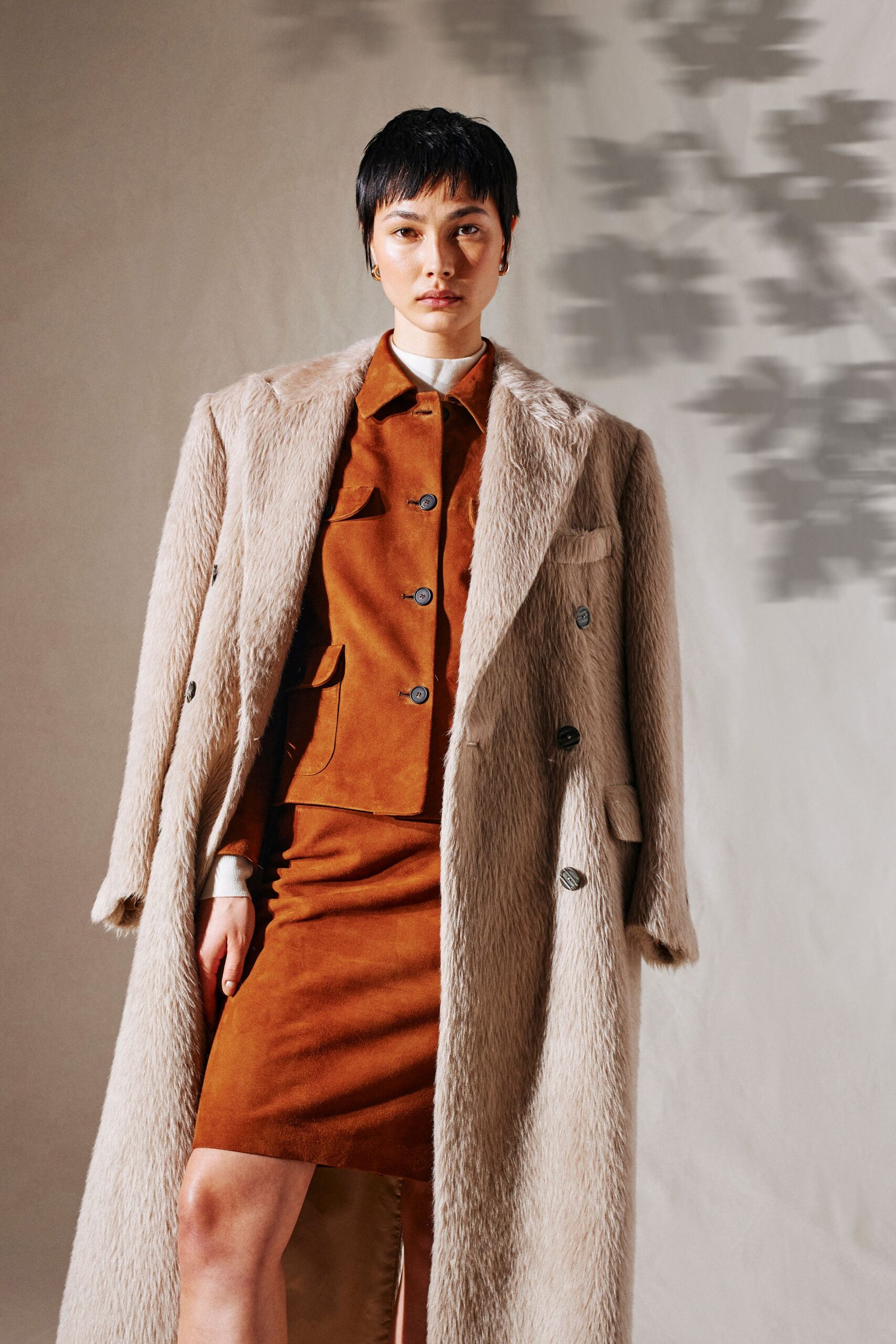 beige faux-fur coat with brown skirt
