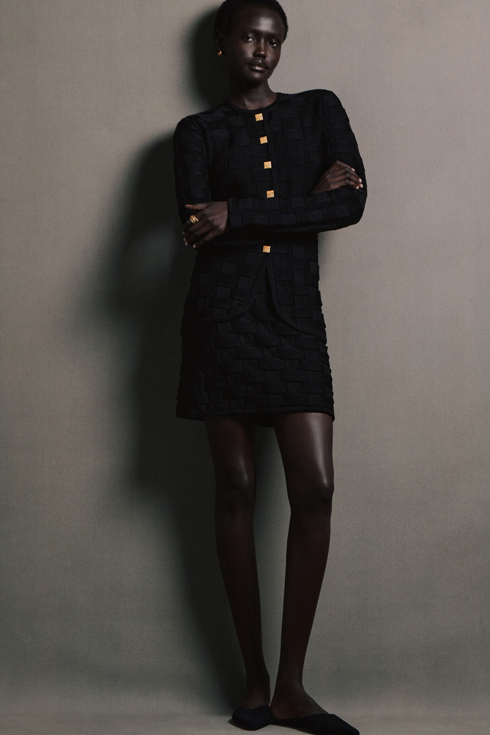 black fitted mini dress with long sleeves