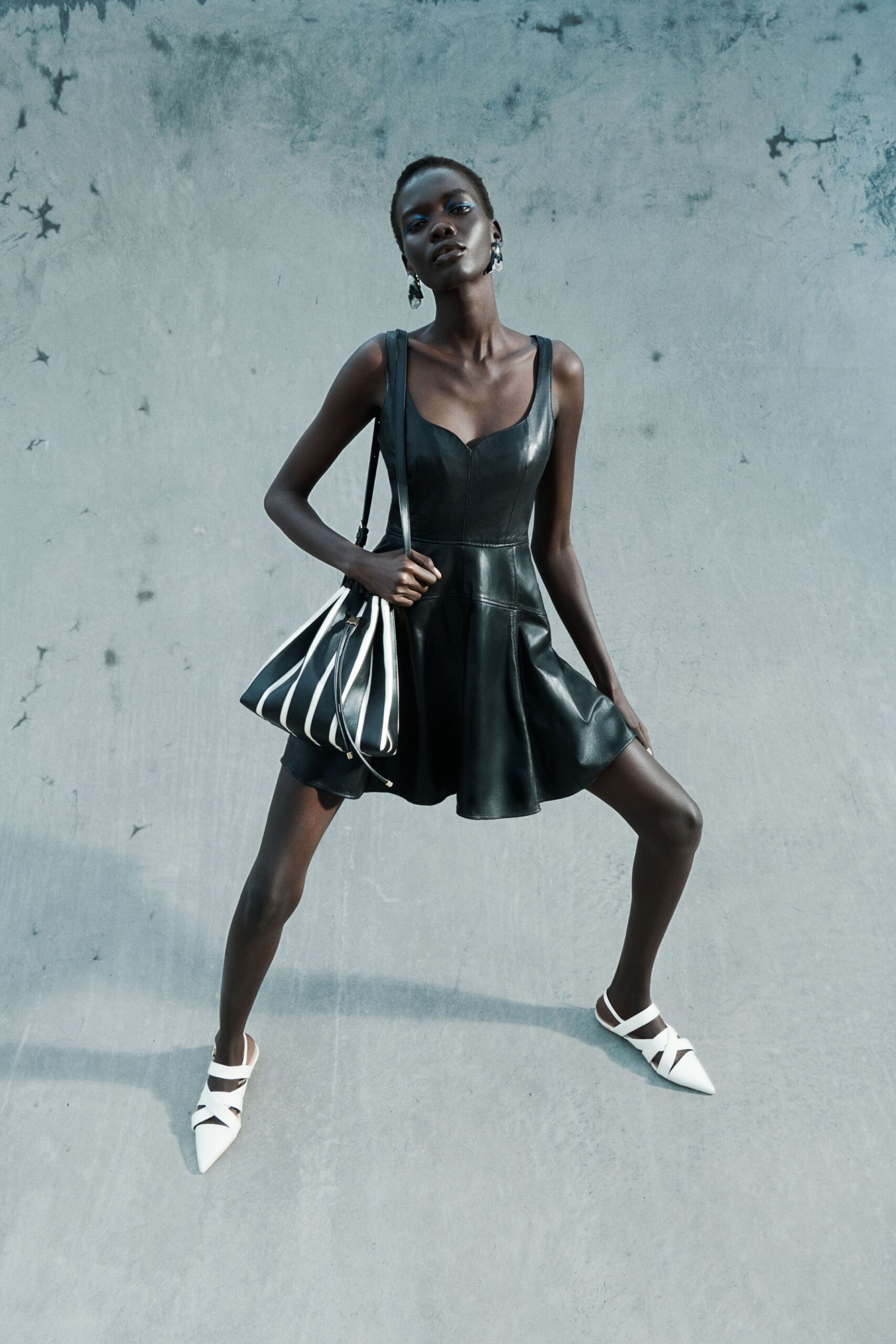 black leather sleeveless sweetheart fitted panelled a-line mini-dress