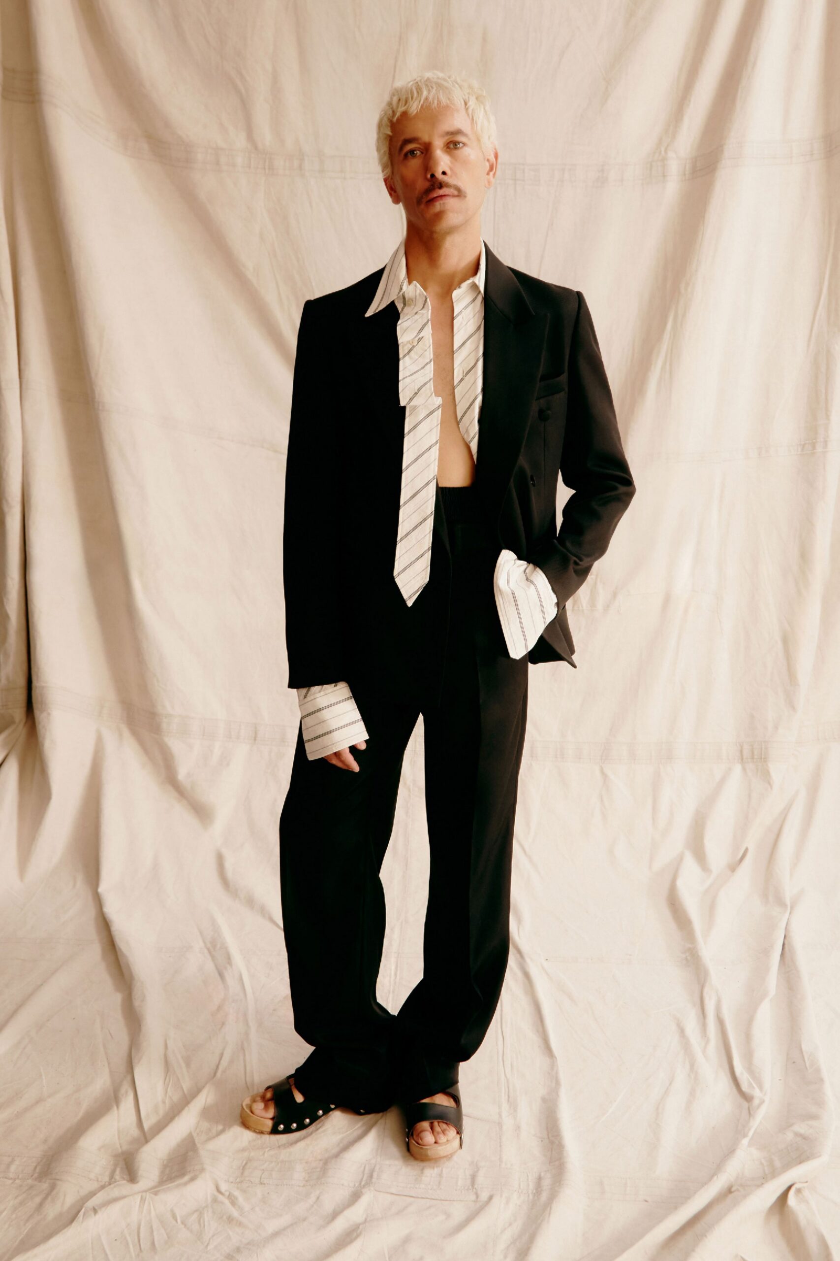 black tailored blazer with striped shirt