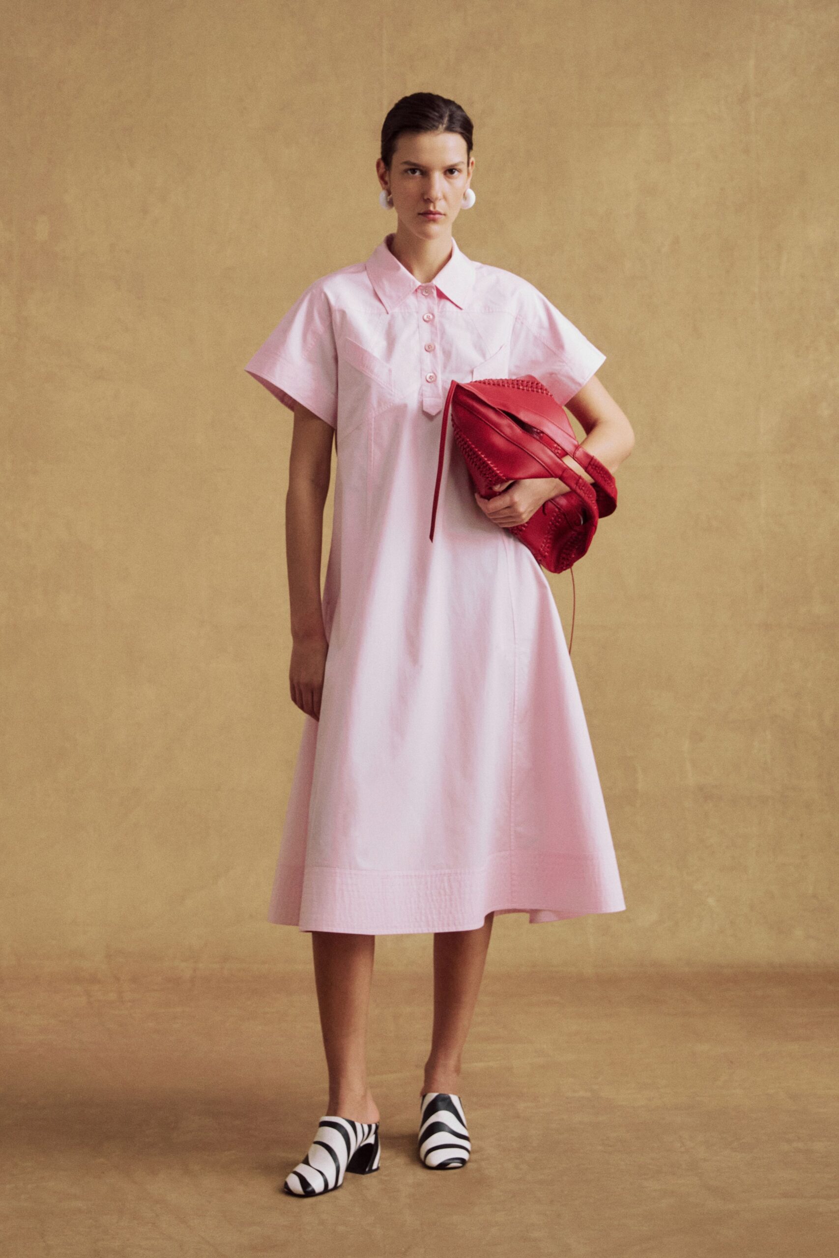 pink midi dress with red bag