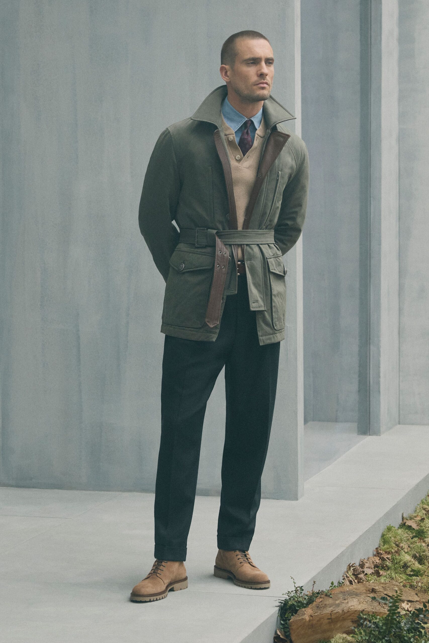 green structured jacket with beige sweater