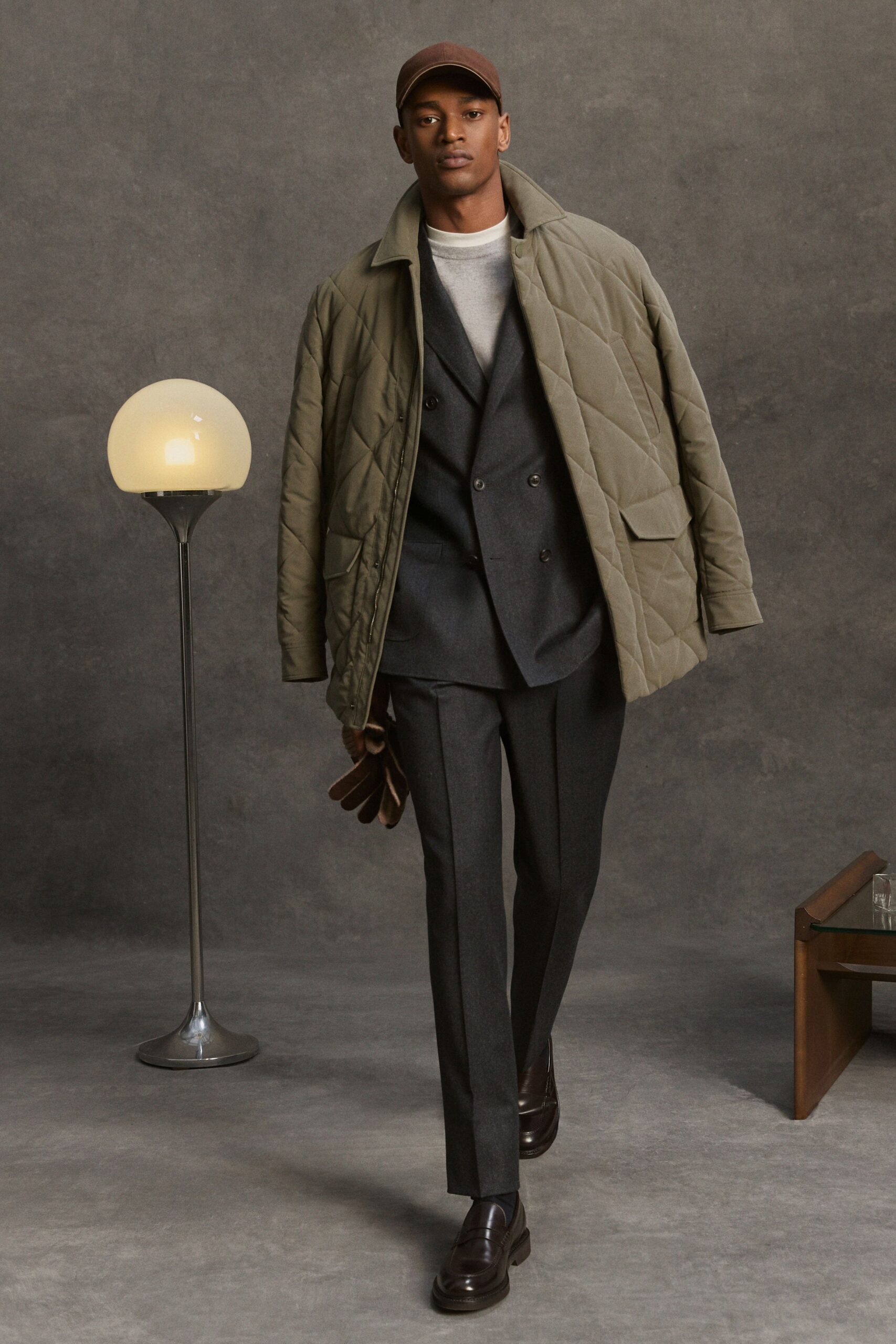 green quilted coat with gray suit
