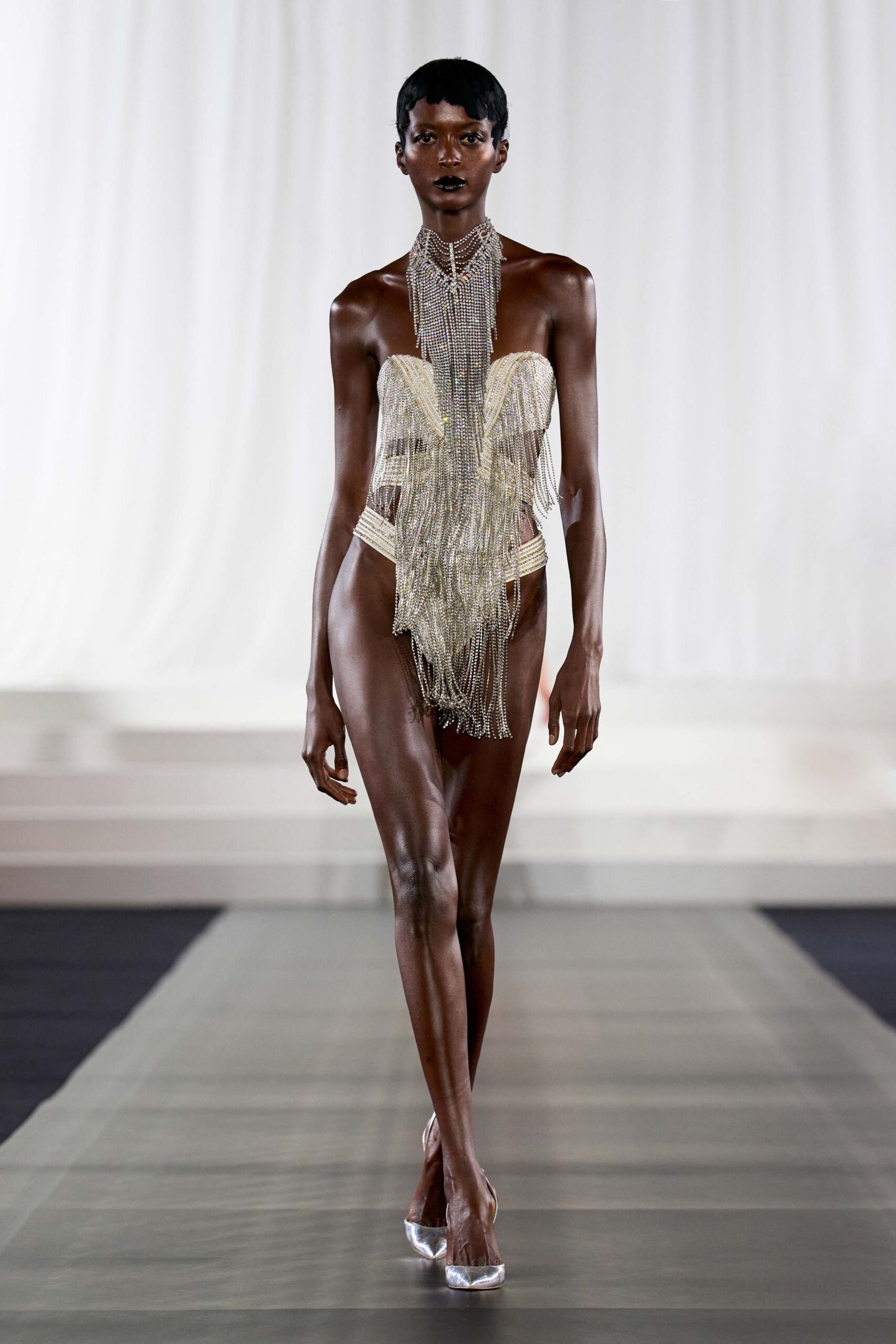 gold fringed bustier with clear shoes