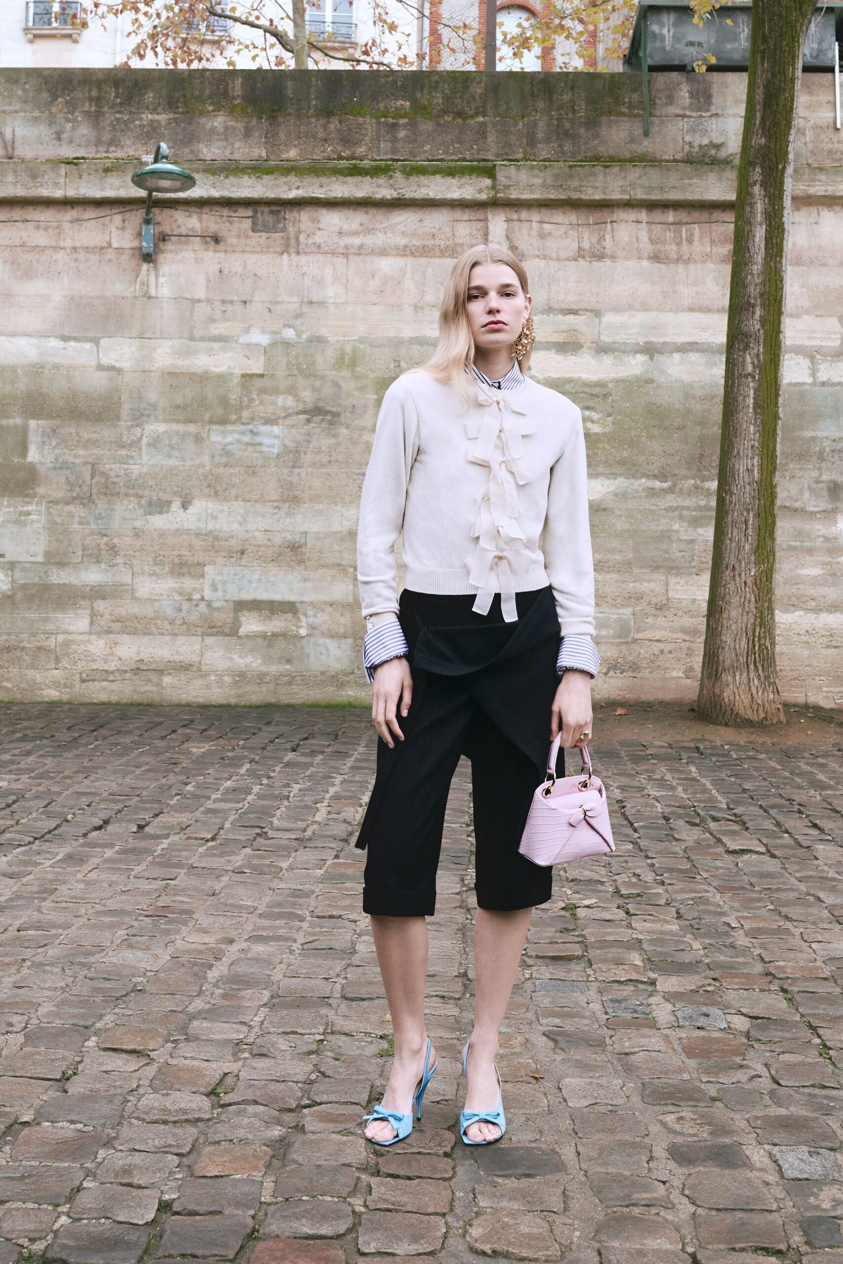 white ruffled shirt with black pants