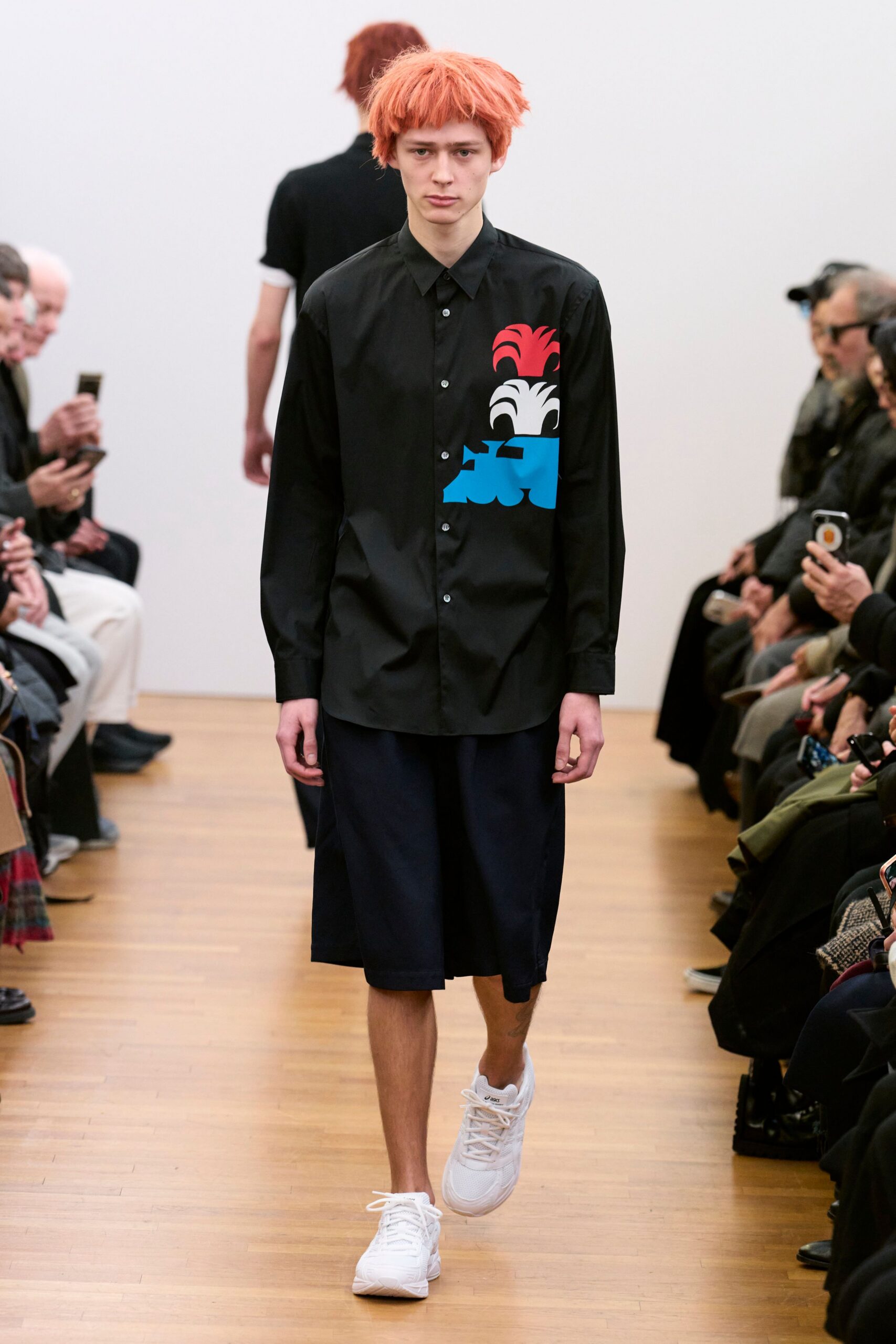 black shirt navy shorts white shoes