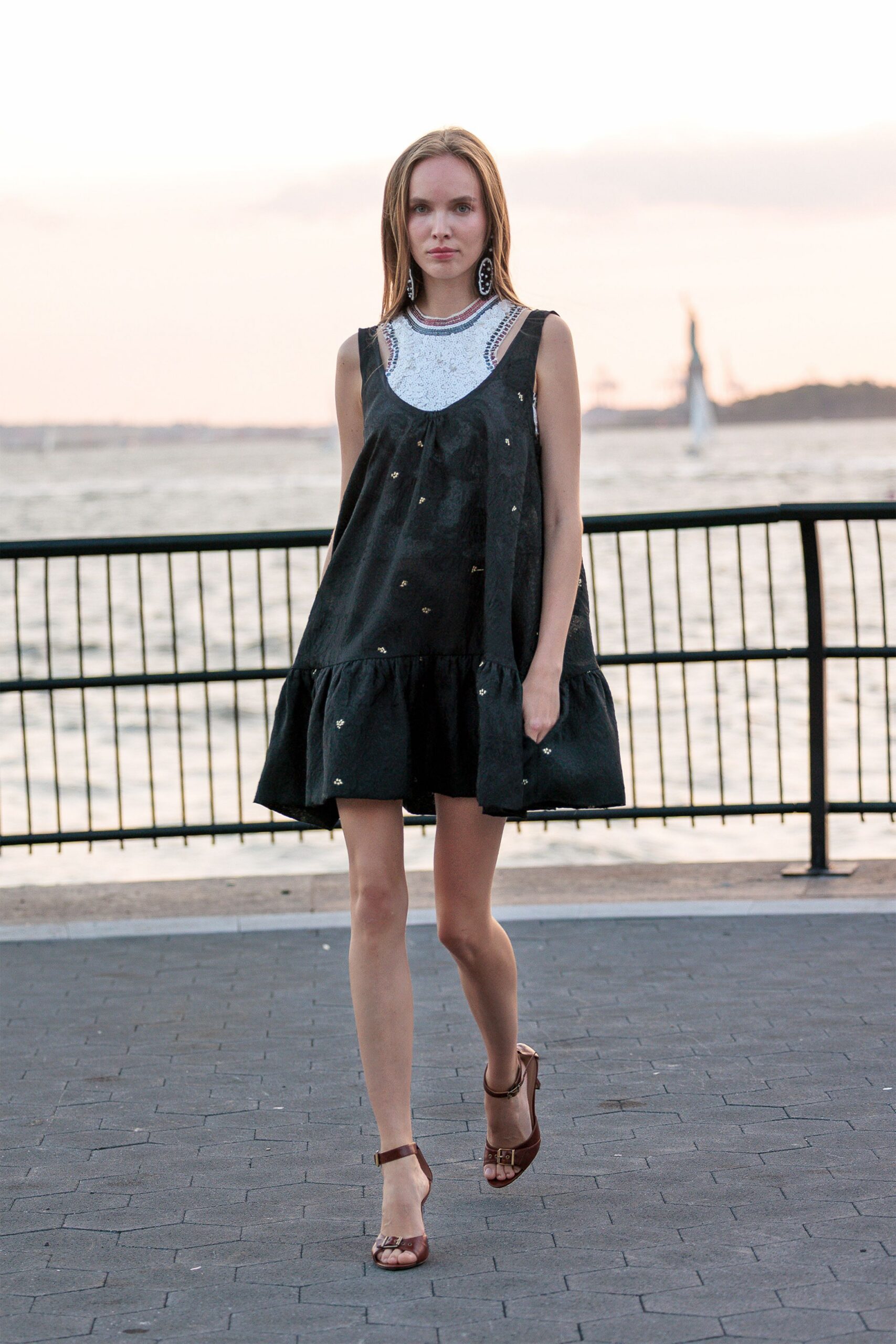 black relaxed mini dress with strappy shoes