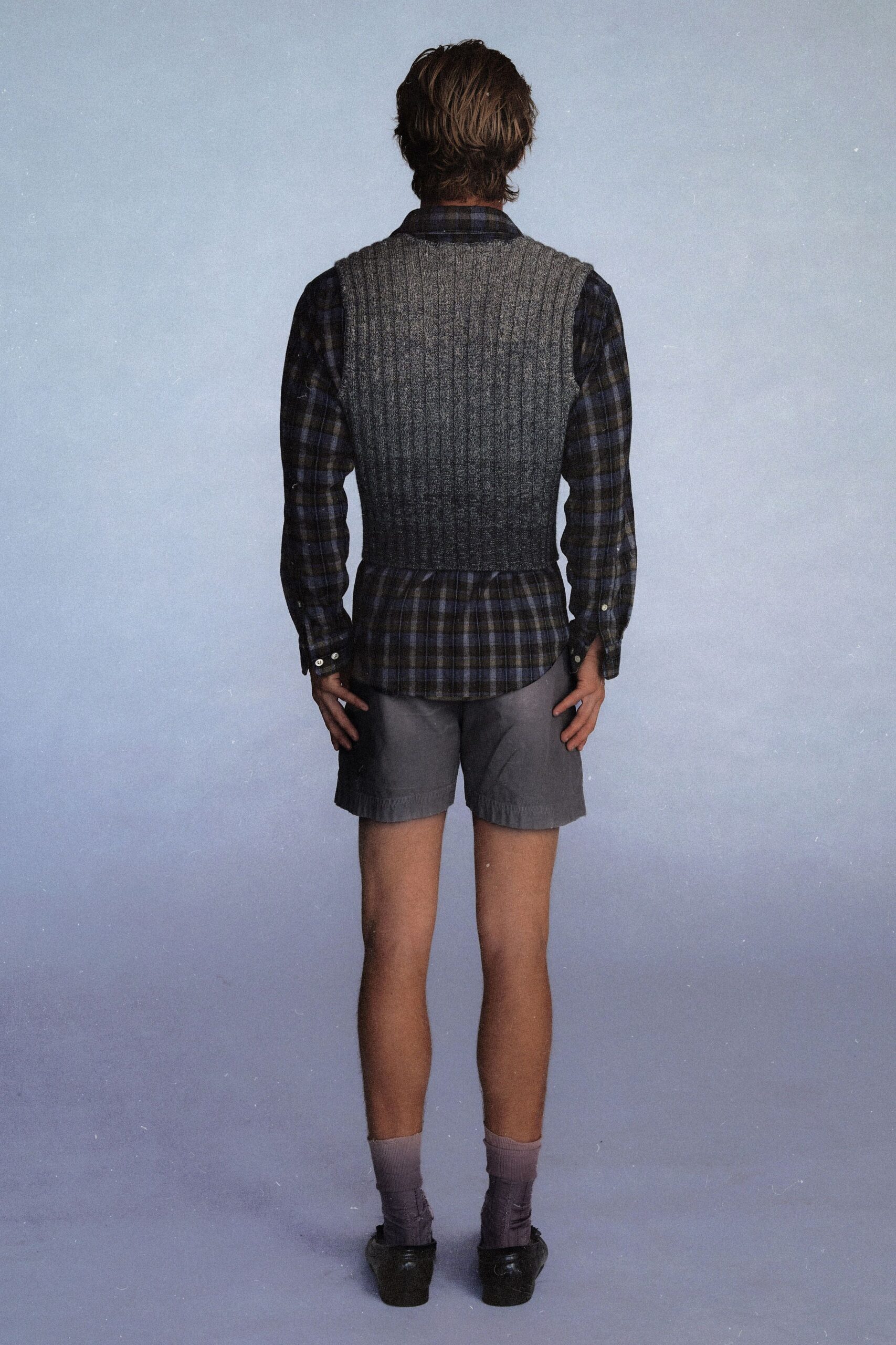 blue checked shirt with gray vest