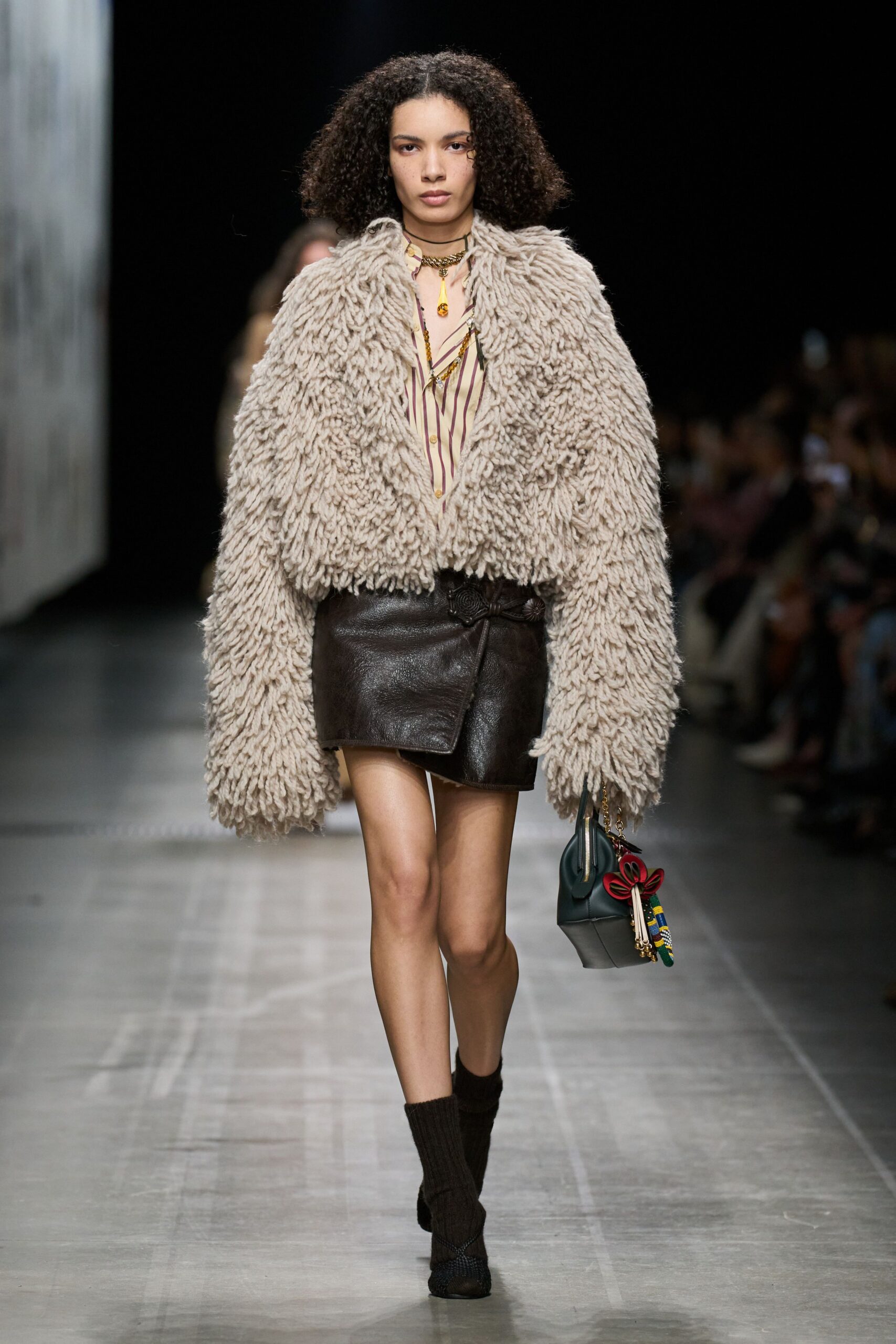 beige fur coat with black leather skirt